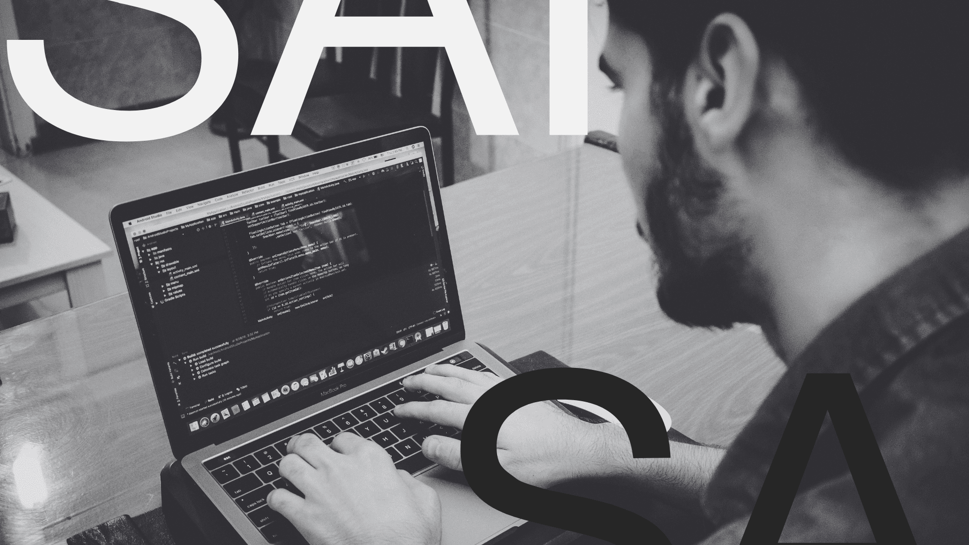 A Team of 4 people looking at the screen of a computer