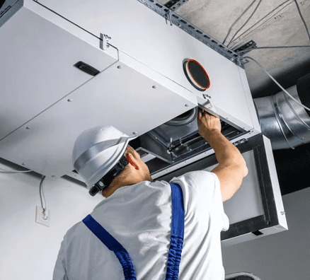 Technician installing an HRV ventilation system to improve indoor air quality in a Mississauga home
