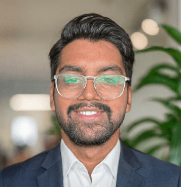 smiling woman wearing white and black pinstriped collared top