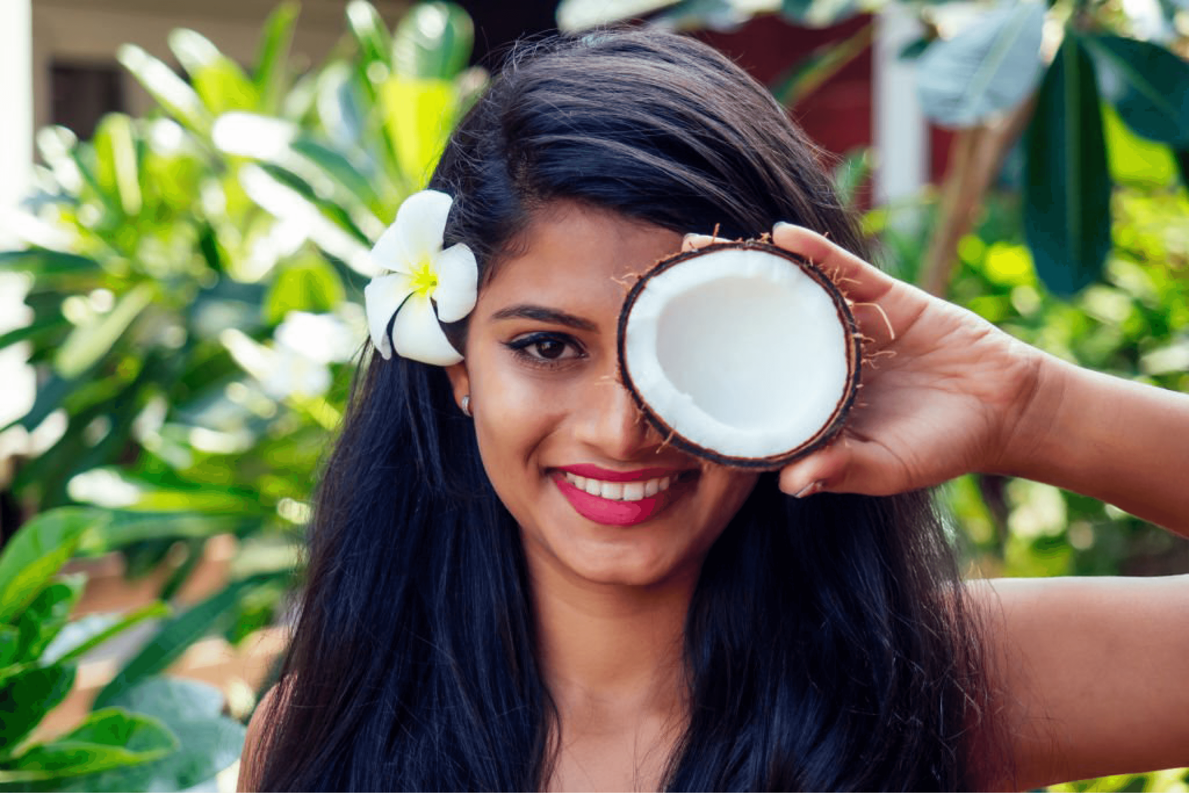 Smiling Indian woman holding half a coconut, highlighting the benefits of coconut oil for natural hair care. hair fall control, home care, hair masks, natural remedies,  Indulekha Bringha Oil Mamaearth Onion Hair Oil Kesh King Scalp and Hair Ayurvedic Oil Biotique Bio Kelp Protein Shampoo WOW Skin Science Apple Cider Vinegar Shampoo Himalaya Herbals Anti-Hair Fall Shampoo Khadi Natural Amla & Bhringraj Shampoo Mamaearth Onion Hair Mask St. Botanica Biotin & Collagen Hair Mask WOW Skin Science Hair Mask Tresemme Keratin Smooth Conditioner Biotique Bio Watercress Fresh Nourishing Conditioner Mamaearth Argan Conditioner Himalaya Hair Zone Tablets HealthKart HK Vitals Biotin Cureveda Grow Plant-Based Biotin The Moms Co. Natural Protein Hair Oil Parachute Advanced Ayurvedic Hot Oil Soulflower Cold-Pressed Castor Oil Just Herbs Silky Strength Shampoo Aroma Magic Triphla Shampoo Vaadi Herbals Amla Shikakai Shampoo Earth Rhythm Pro-Vitamin B5 Hair Mask Anveya Hydrate and Nourish Hair Mask L'Oréal Paris Extraordinary Oil Serum Kapiva Hair Care Juice