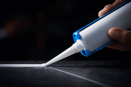 A white tiled shower with a glass door