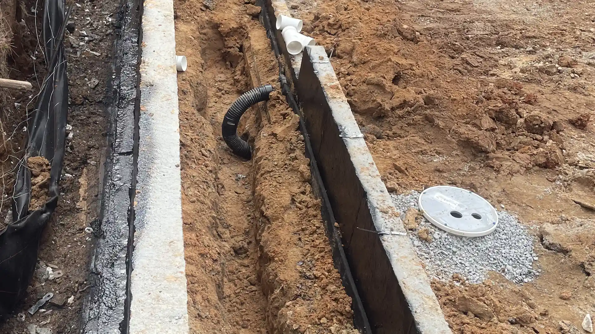 Rub-R-Drain strip drain leading to a sump bucket