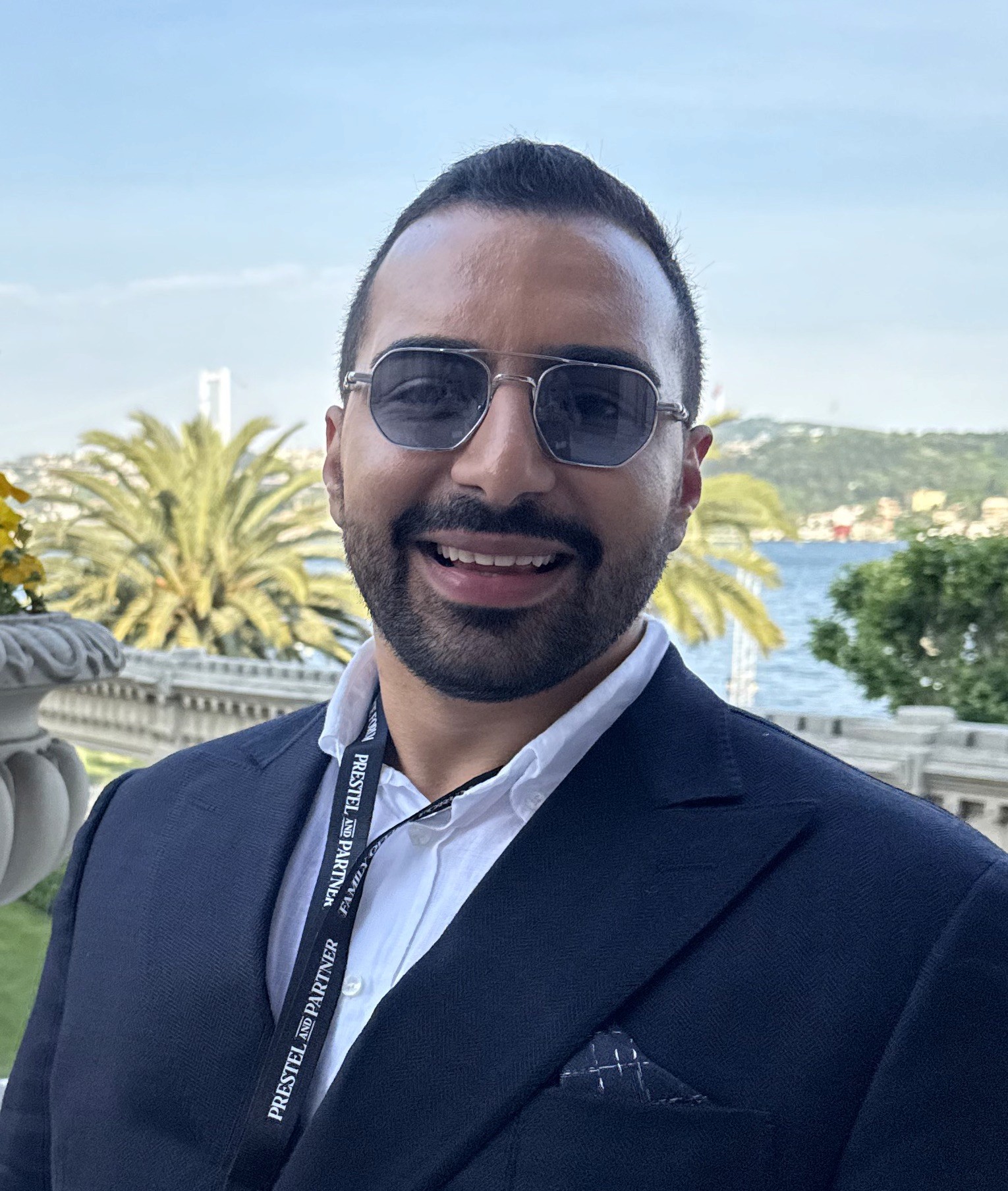 A young person with long, wavy hair sits in front of a plain background, looking directly at the camera.