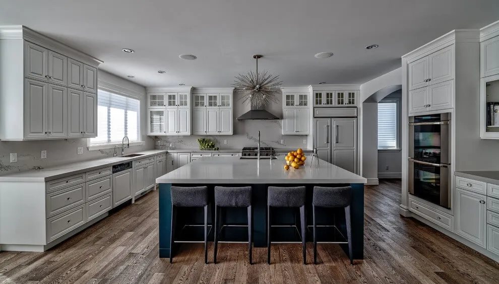 Image of Luxury kitchen design with island, white cabinets, and marble backsplash by KHD Homes interior designers.