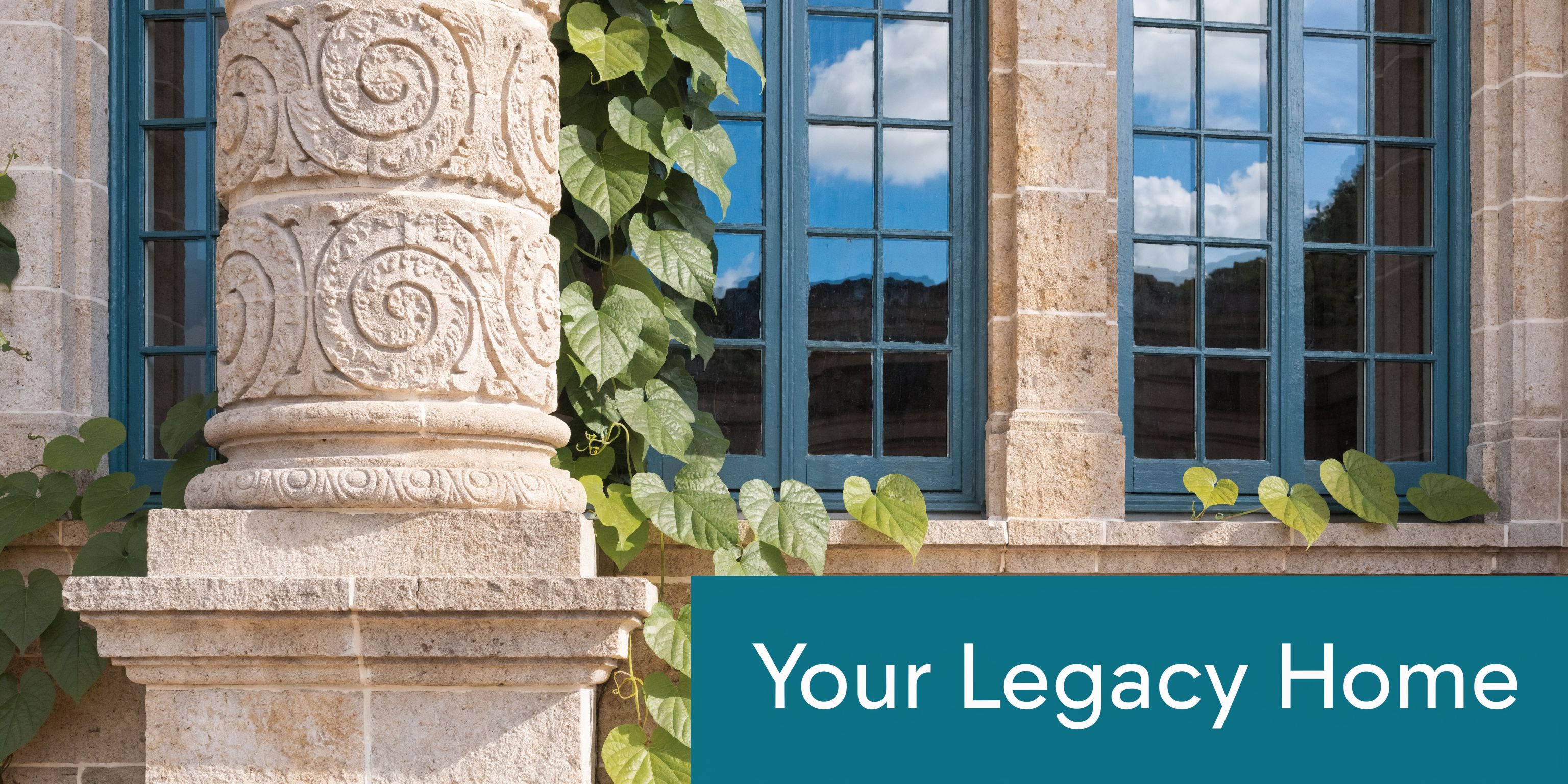 An elegant stone pillar and large windows with climbing ivy plants on a historic building facade.