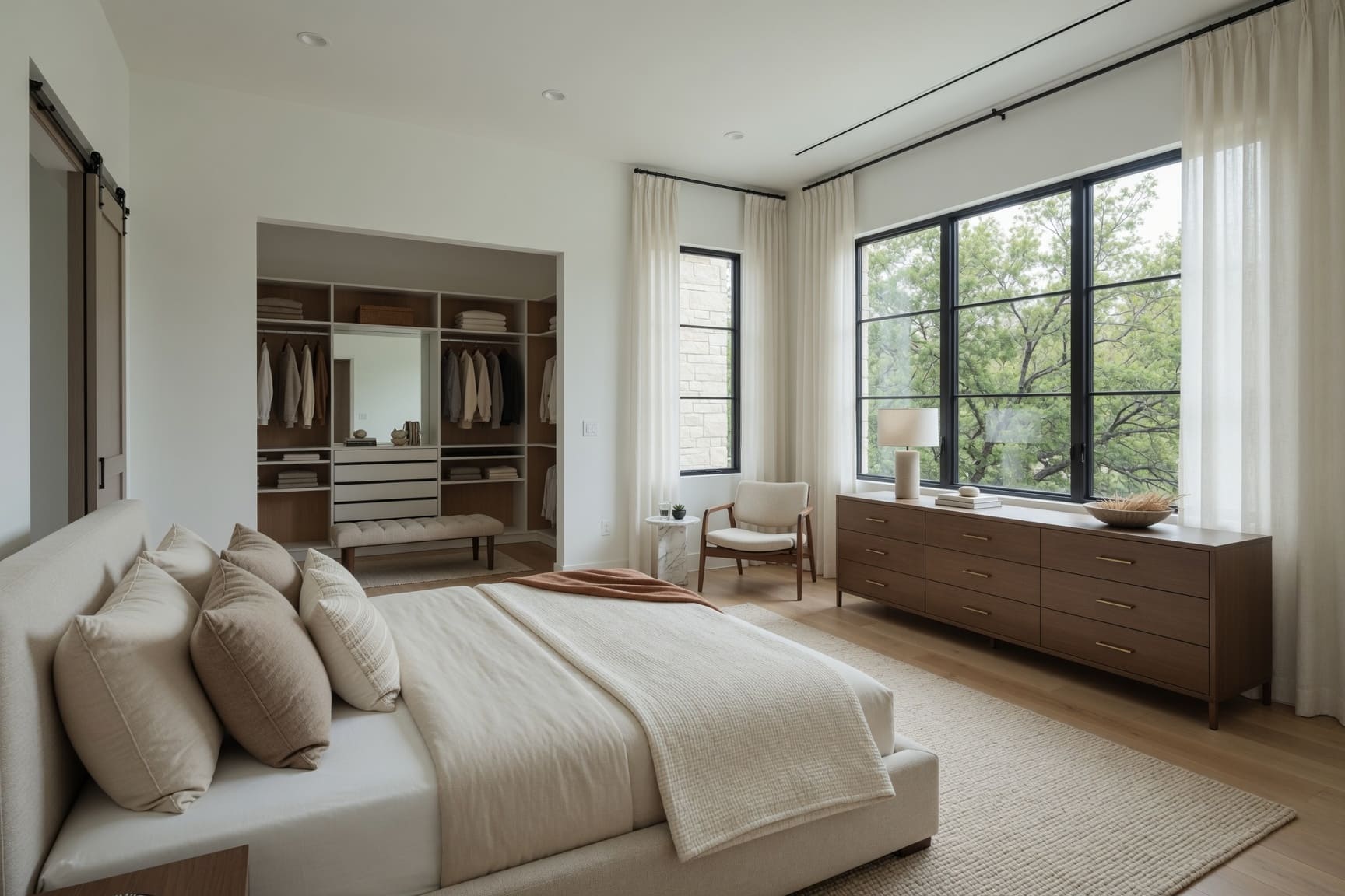 Primary bedroom with walk-in closet and garden views