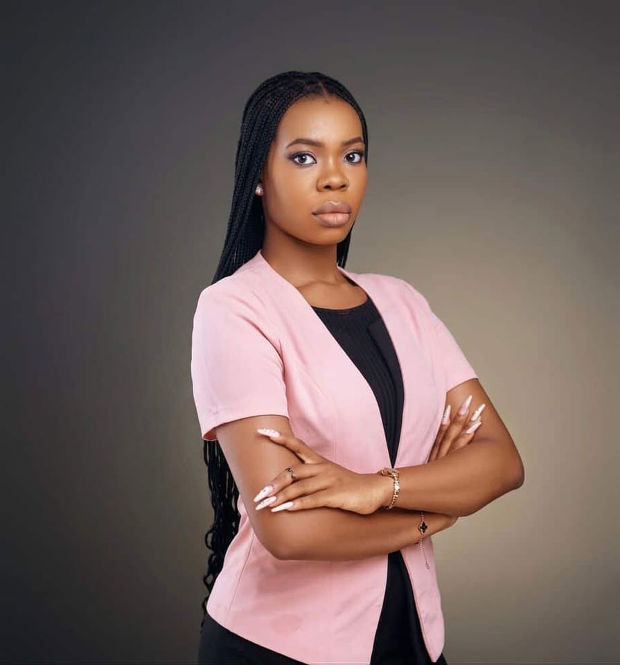 smiling woman sitting on grass during daytime