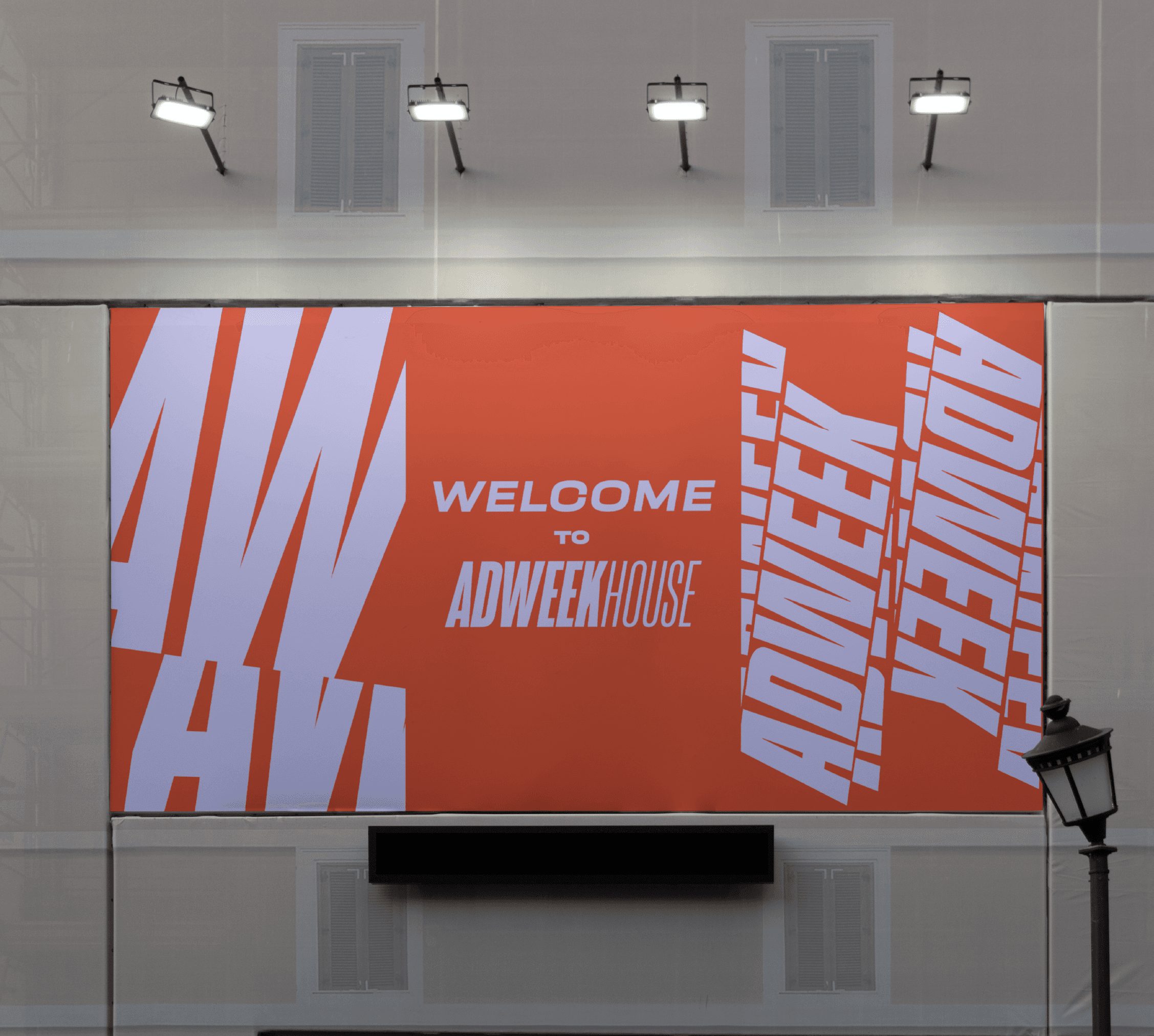 A close-up of a hand wearing multiple decorative rings against a blue background.