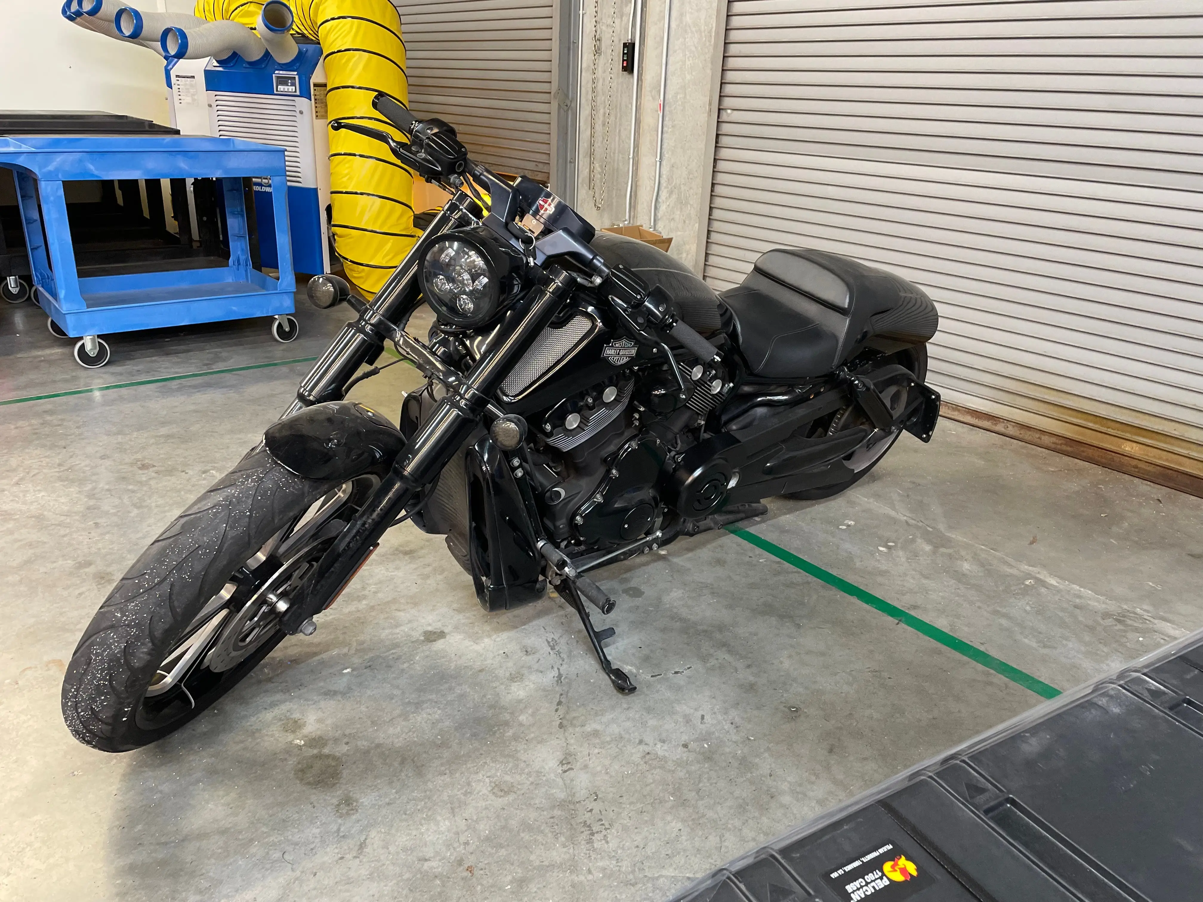 Spacious, luxurious living room with high ceilings, an elegant beige sectional sofa, warm ambient lighting, classical artwork, and rustic architectural elements, featuring an open layout with a view of a mezzanine level.