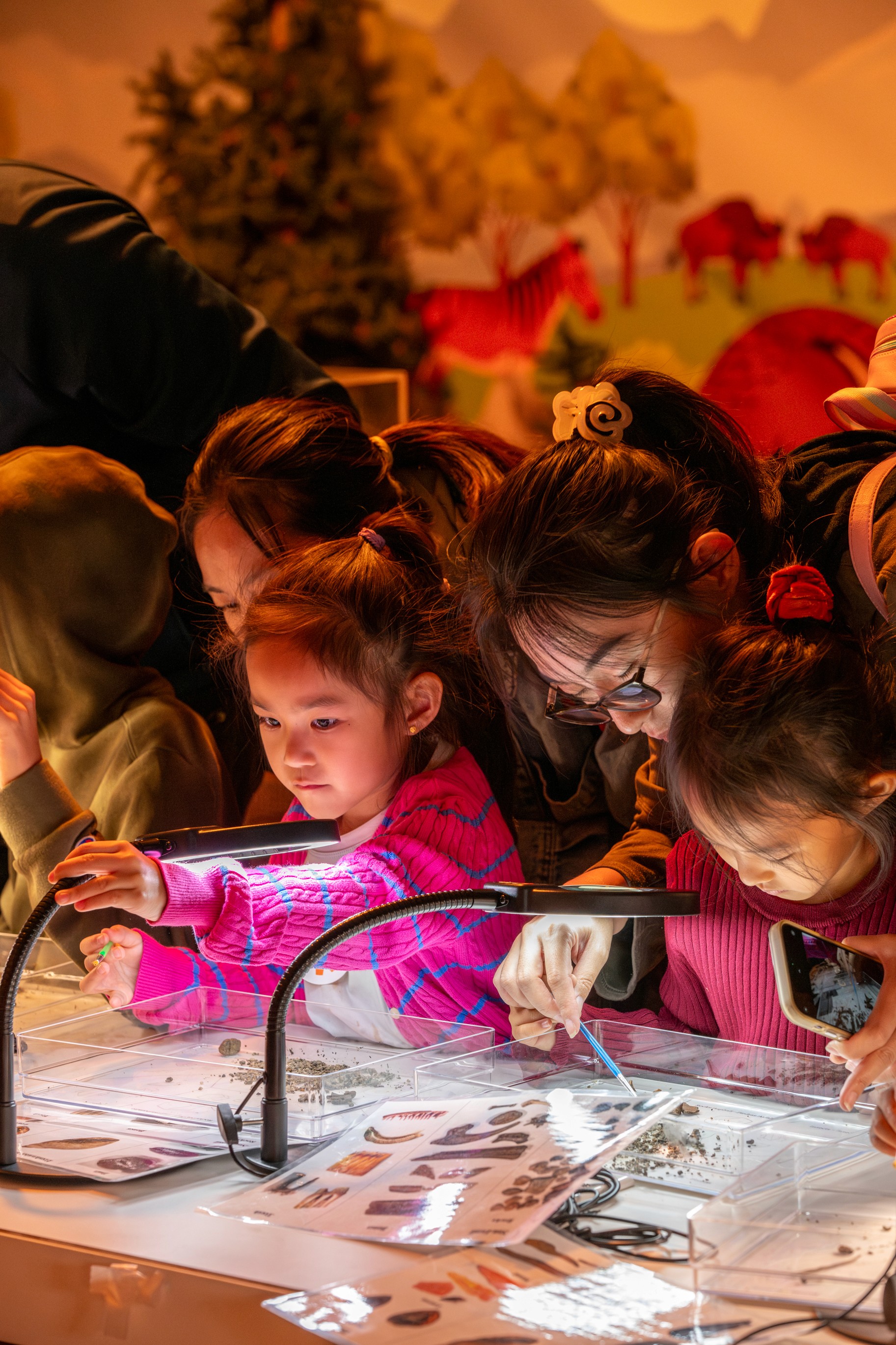 A child interacting with a water-based science exhibit, showcasing accessible event design.