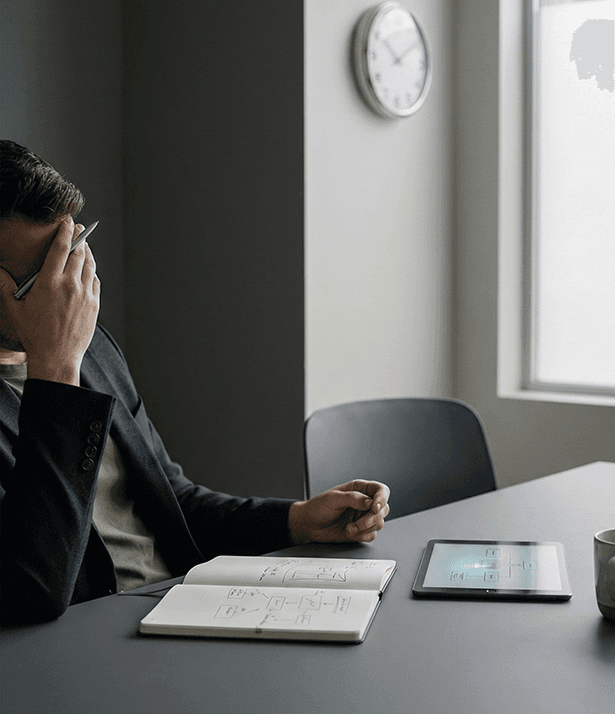 three men laughing while looking in the laptop inside room