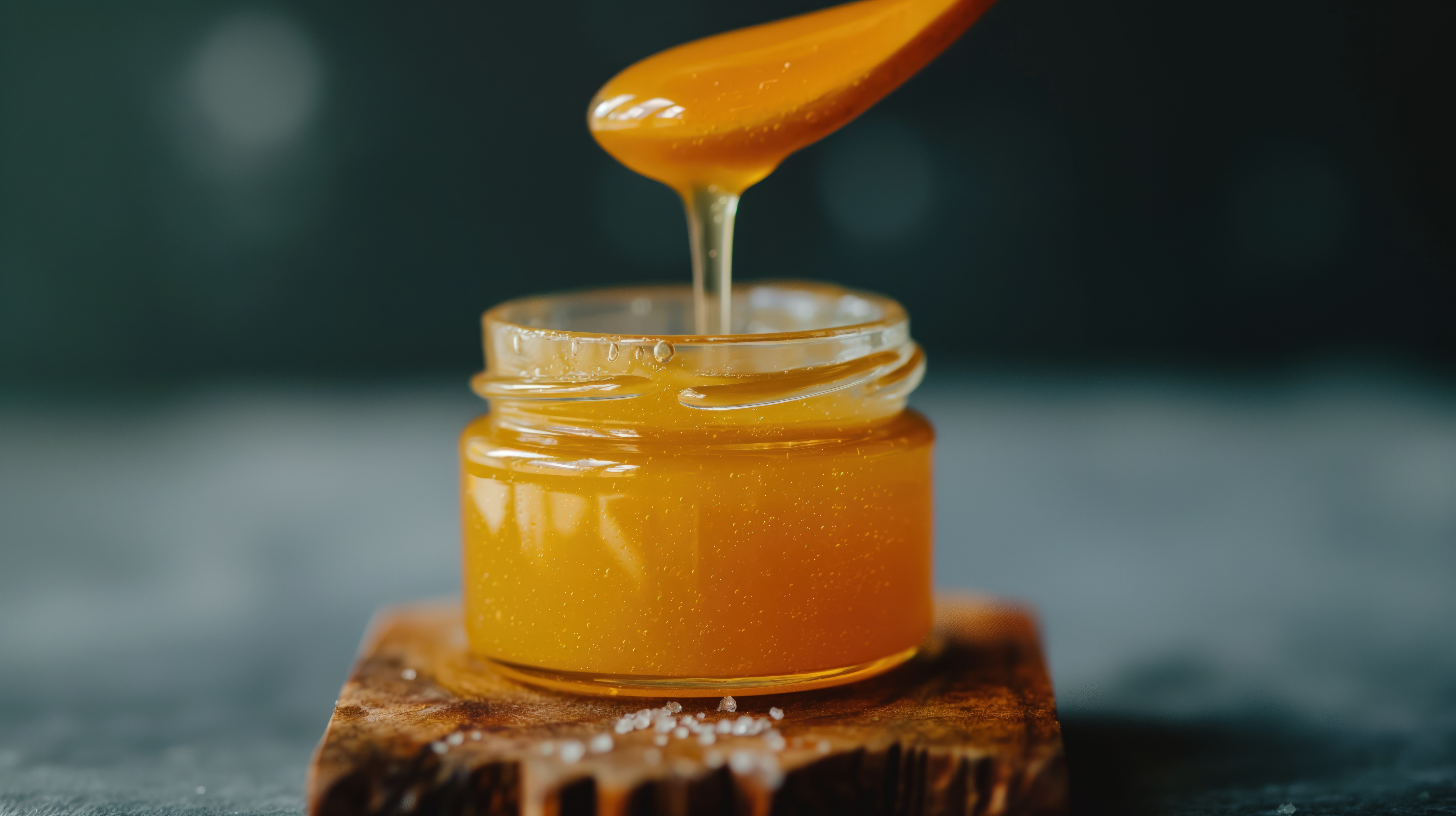 Honey Being Scooped From a Pot