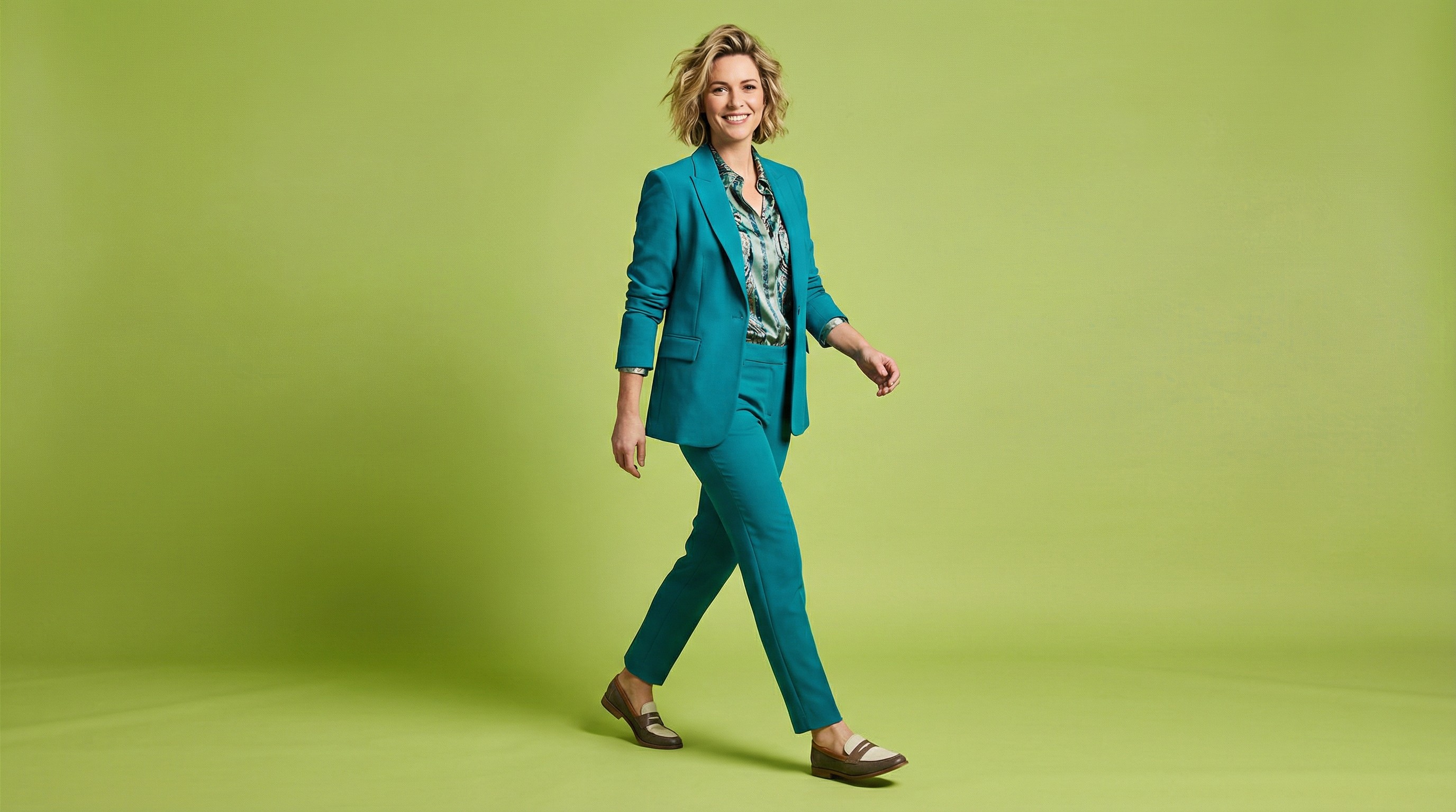 Close-up of lush, dark green leaves, some glossy and wet, against a muted background.