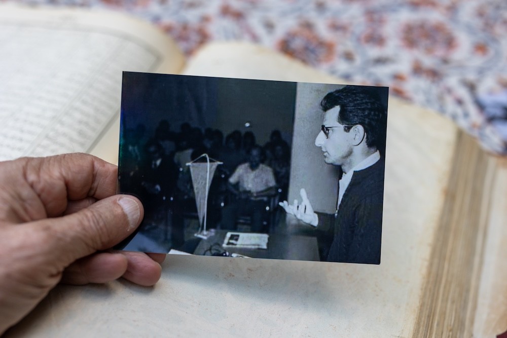 Bubjan with book and speaking to camera