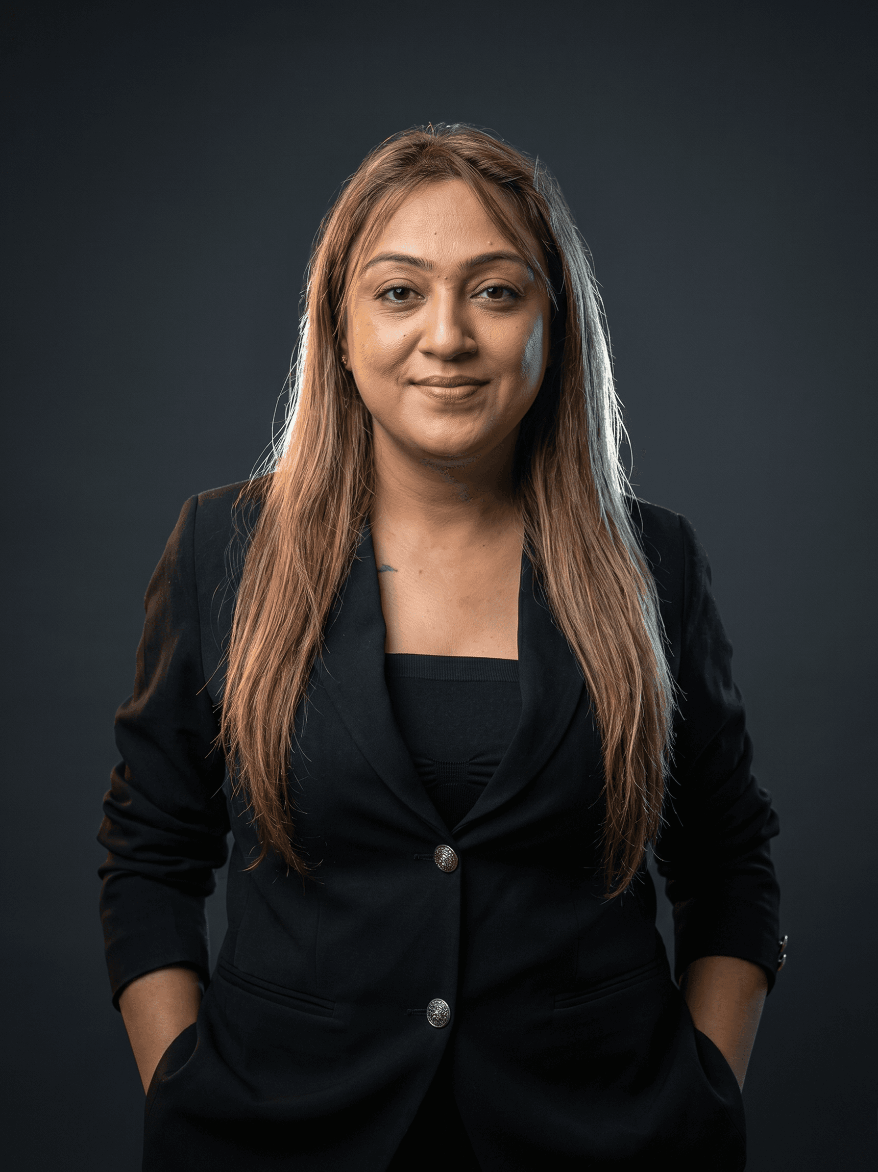 Professional portrait of Rankawat Group Jaipur team member in formal black suit and white shirt, confident corporate profile headshot for real estate company website.
