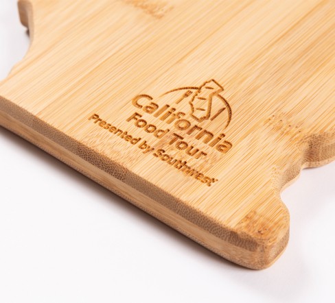 Close up image of cutting board showing the engrained logo for the food tour