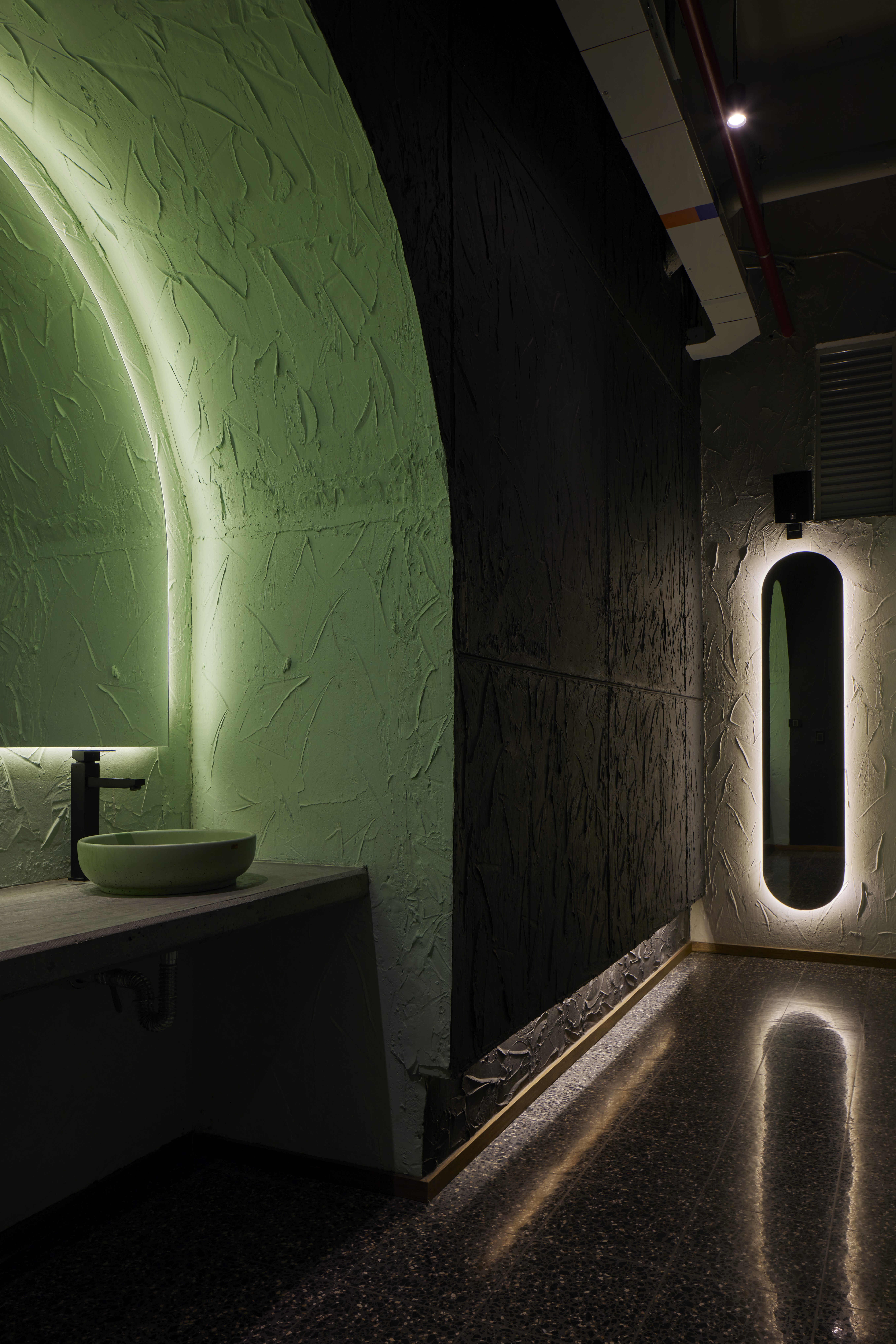 Double-height interior with flowing sculptural forms and warm raking light