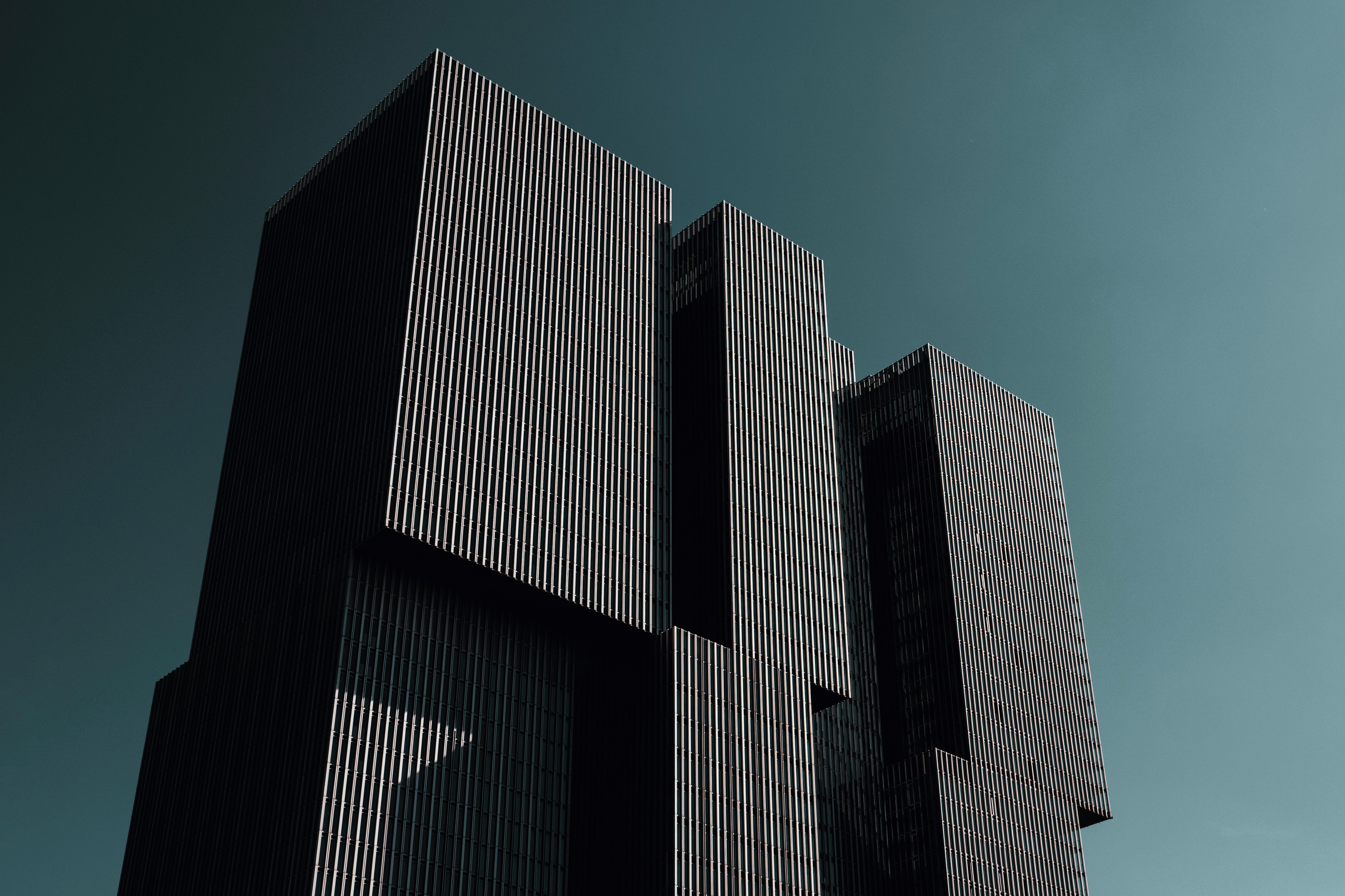 Modern high-rise architectural towers with minimal facade design and dramatic lighting