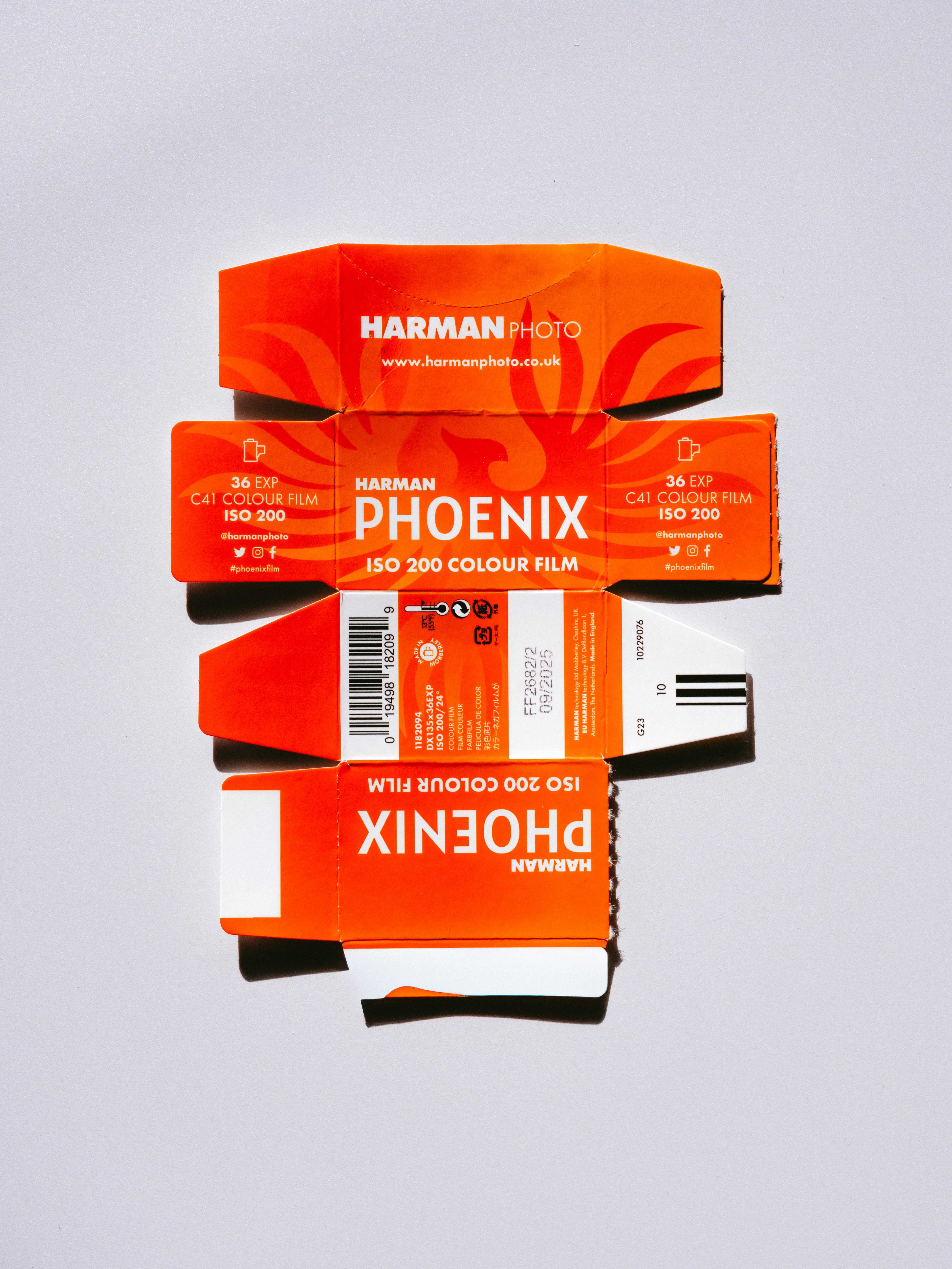 Orange and white film boxes on a white surface