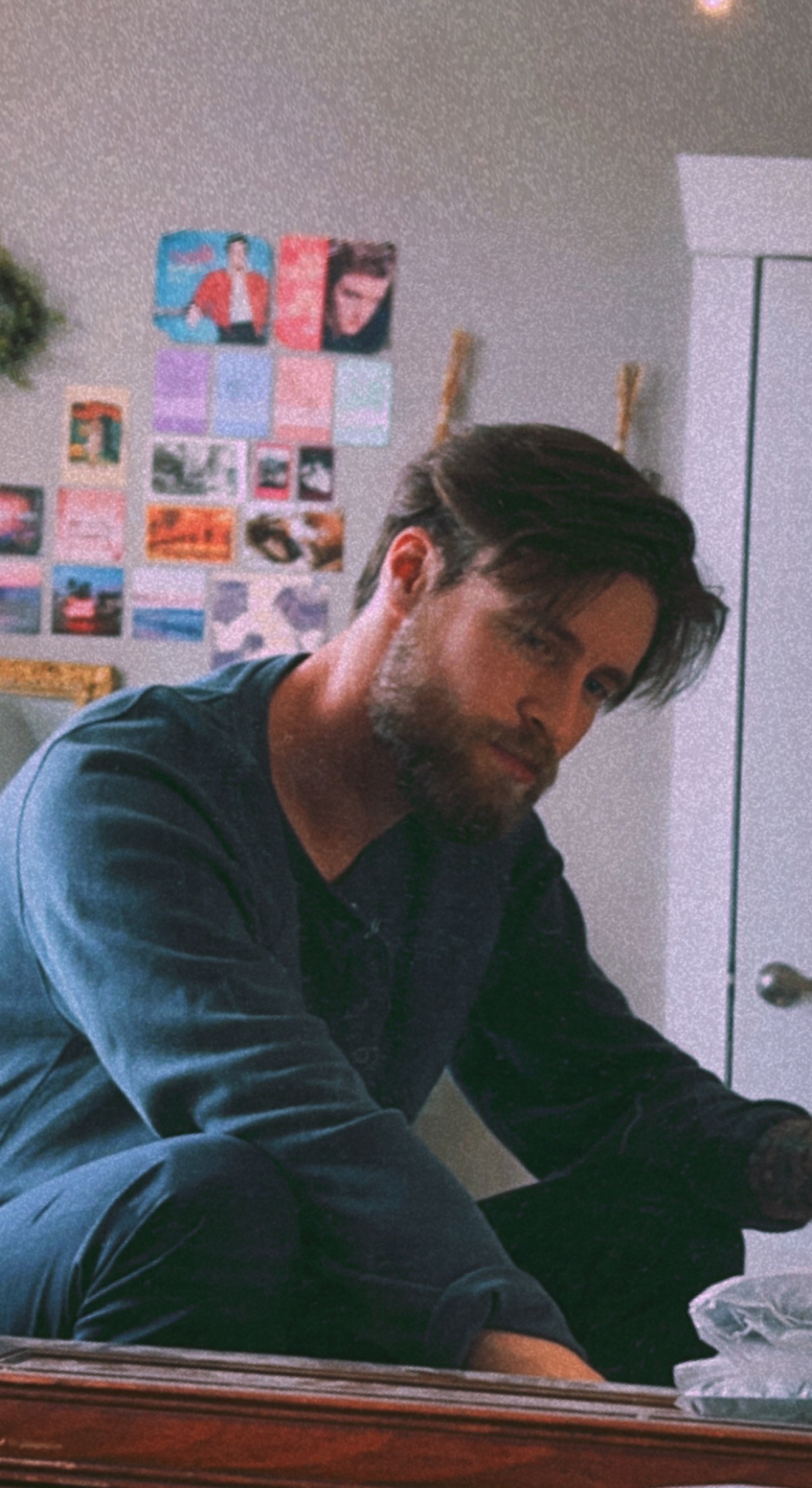 Black and white portrait of a smiling person with curly hair