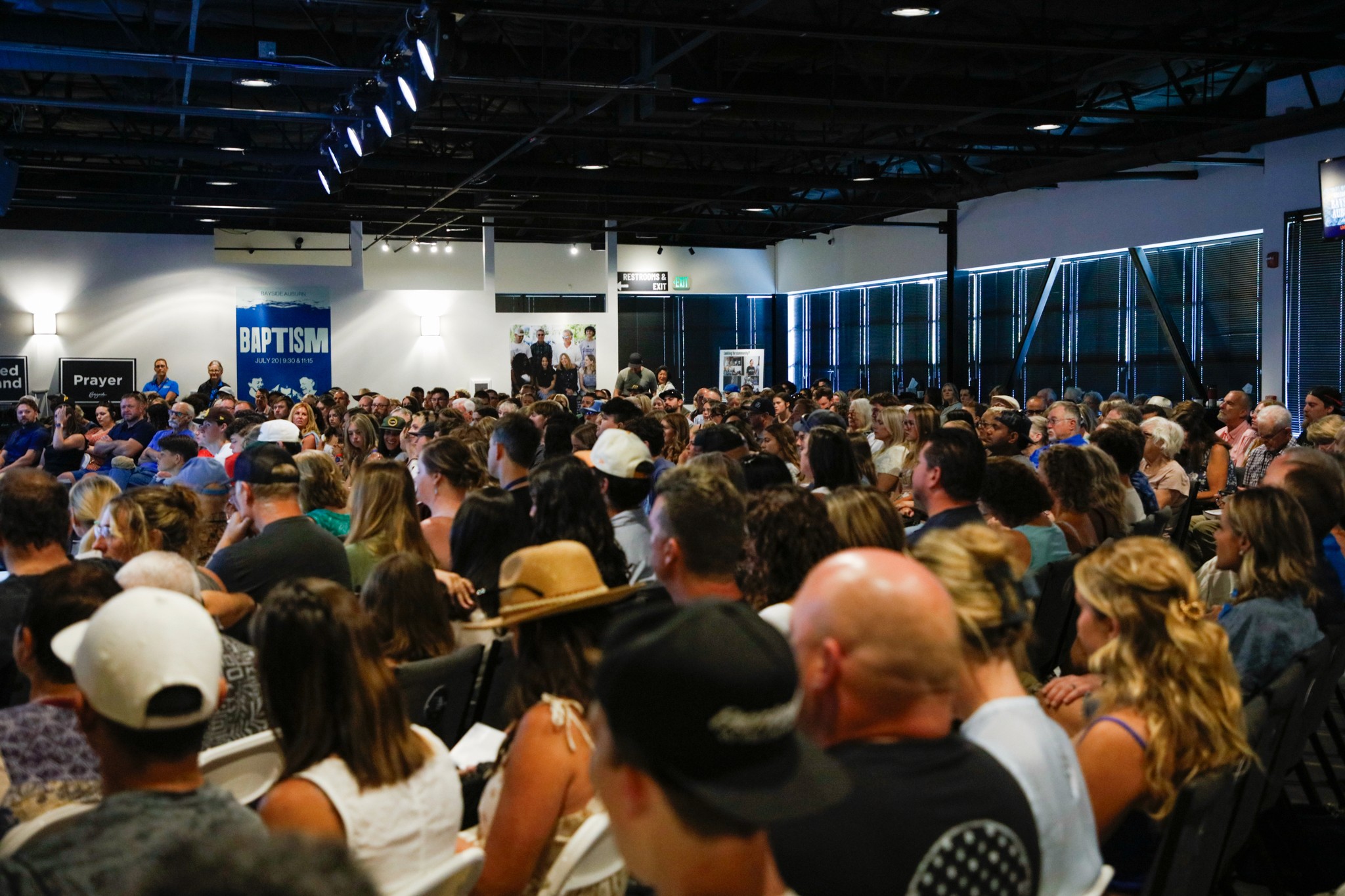 two people in a workspace working on their laptops