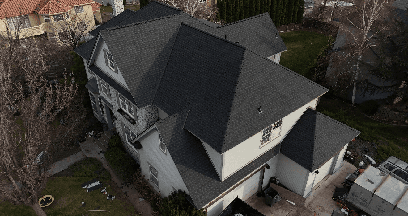 Exposed roof flashing and shingles showing signs of wear, a common source of roof leaks.