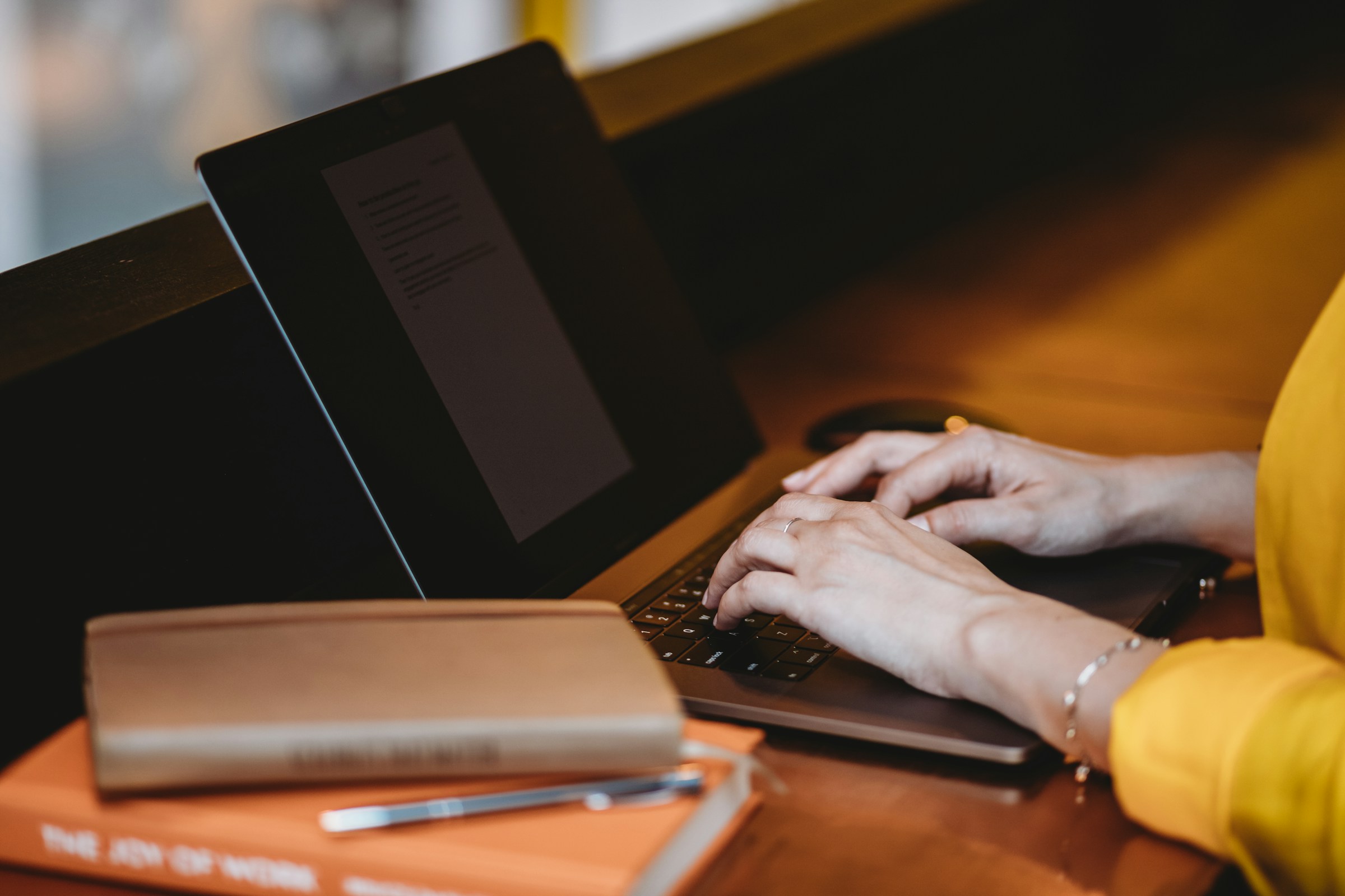 woman typing on laptop - Best AI for Writing Research Papers