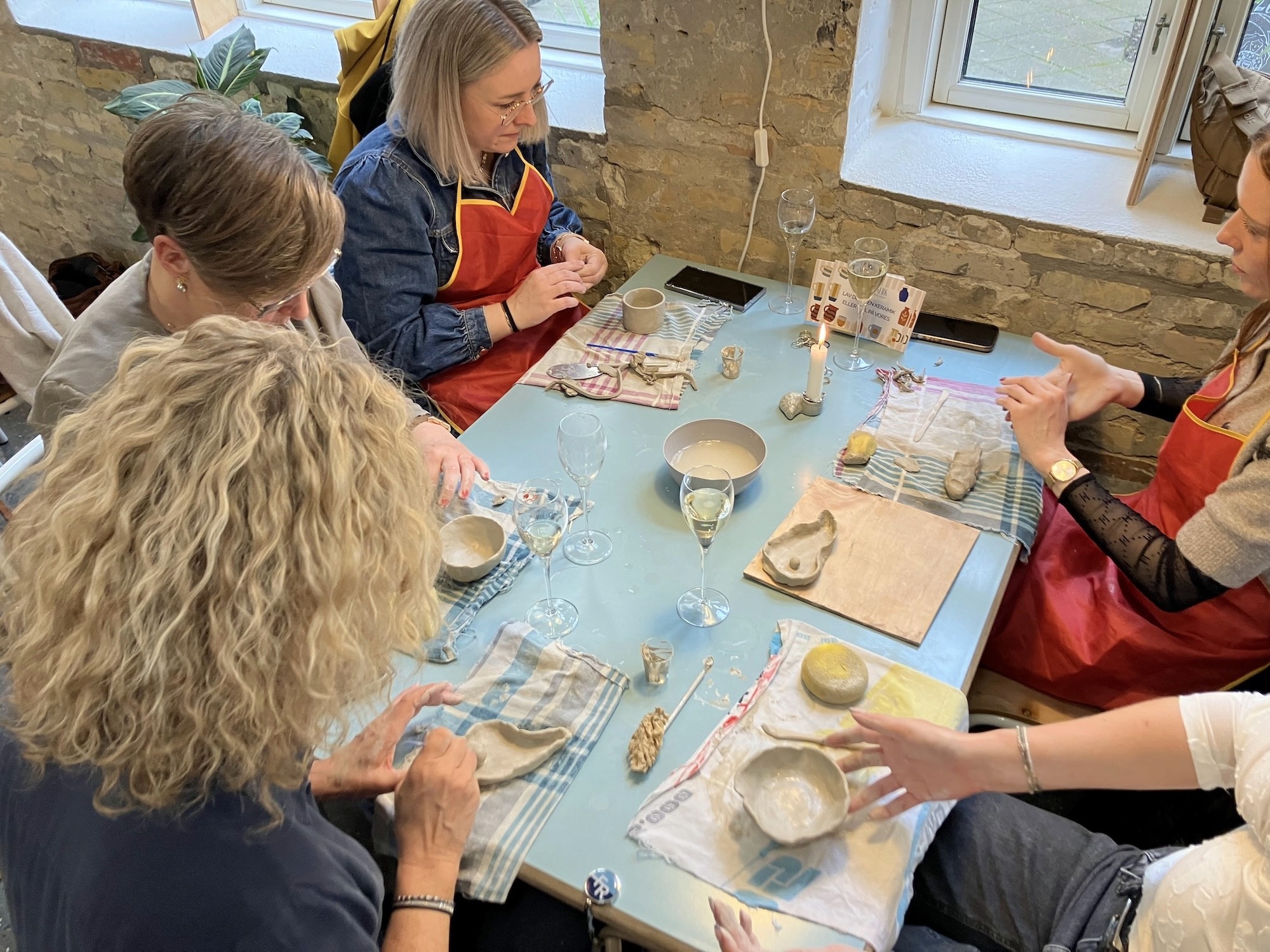a group of friends working with clay