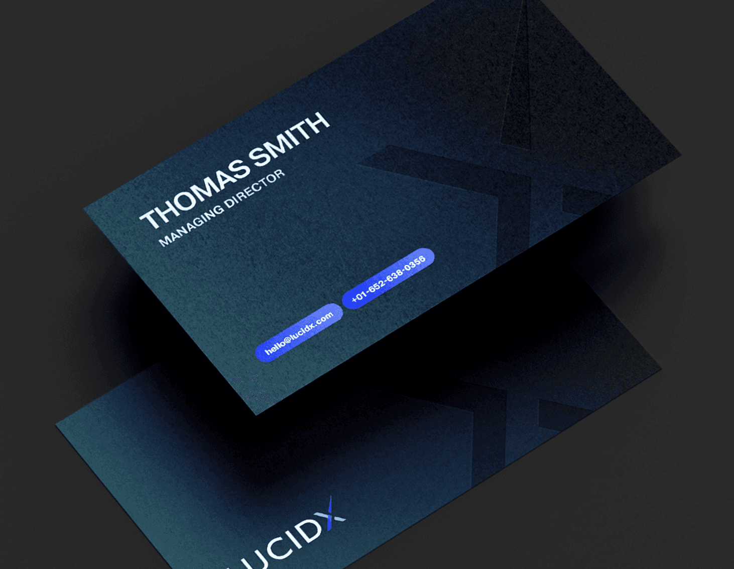 Black and white image of people working at a table with laptops, showing hands gesturing during discussion of digital content displayed on screens, with fabrica® logo in the corner.