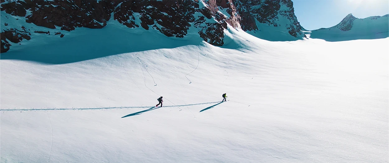 Two people walking on big white open field