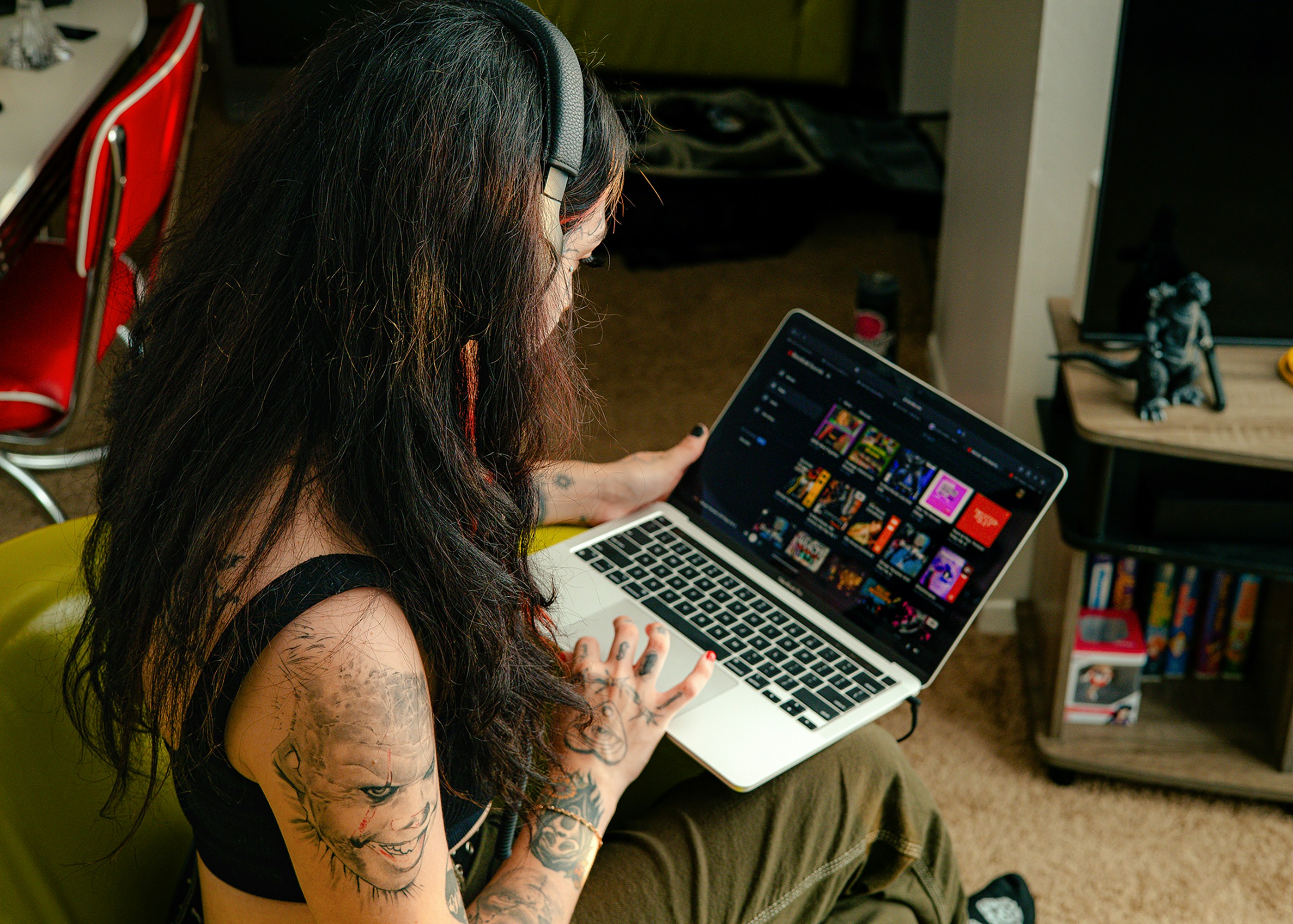 A woman browsing a music library on laptop