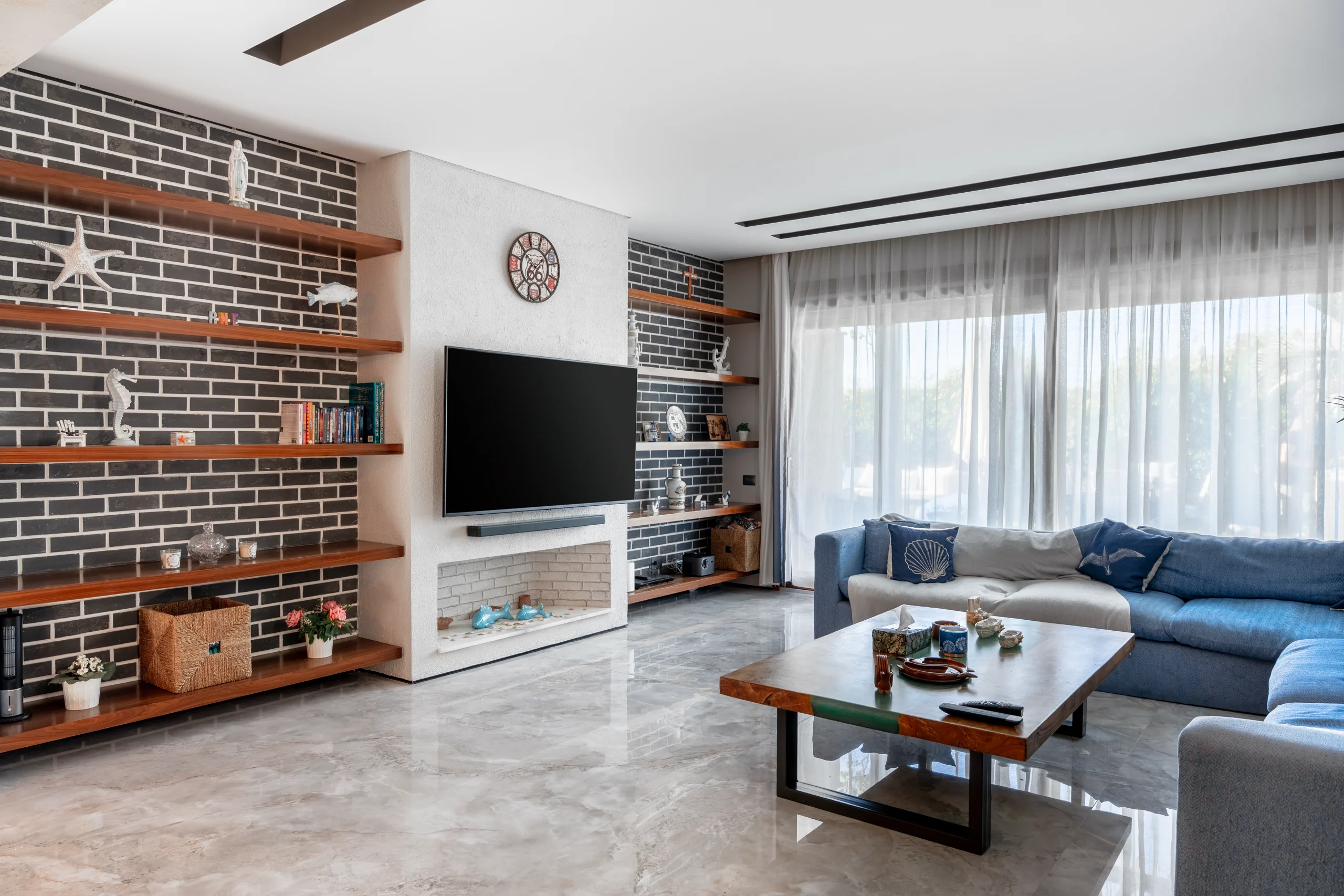 Wide living room and custom media wall at Caesar SODIC Villa in the North Coast.