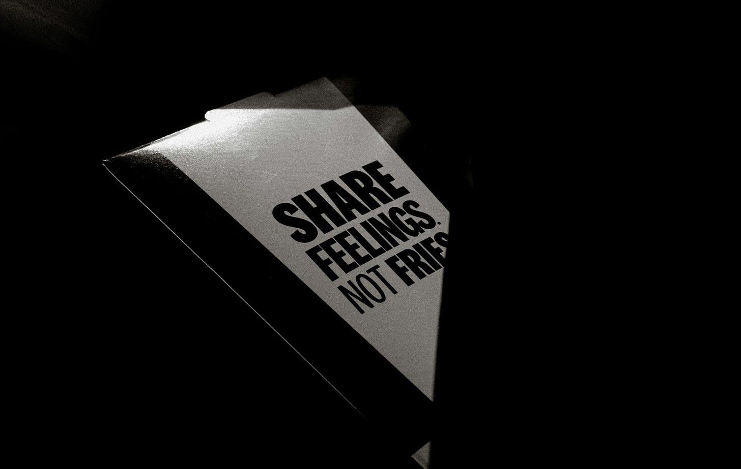 A sign reads "share feelings not fries"