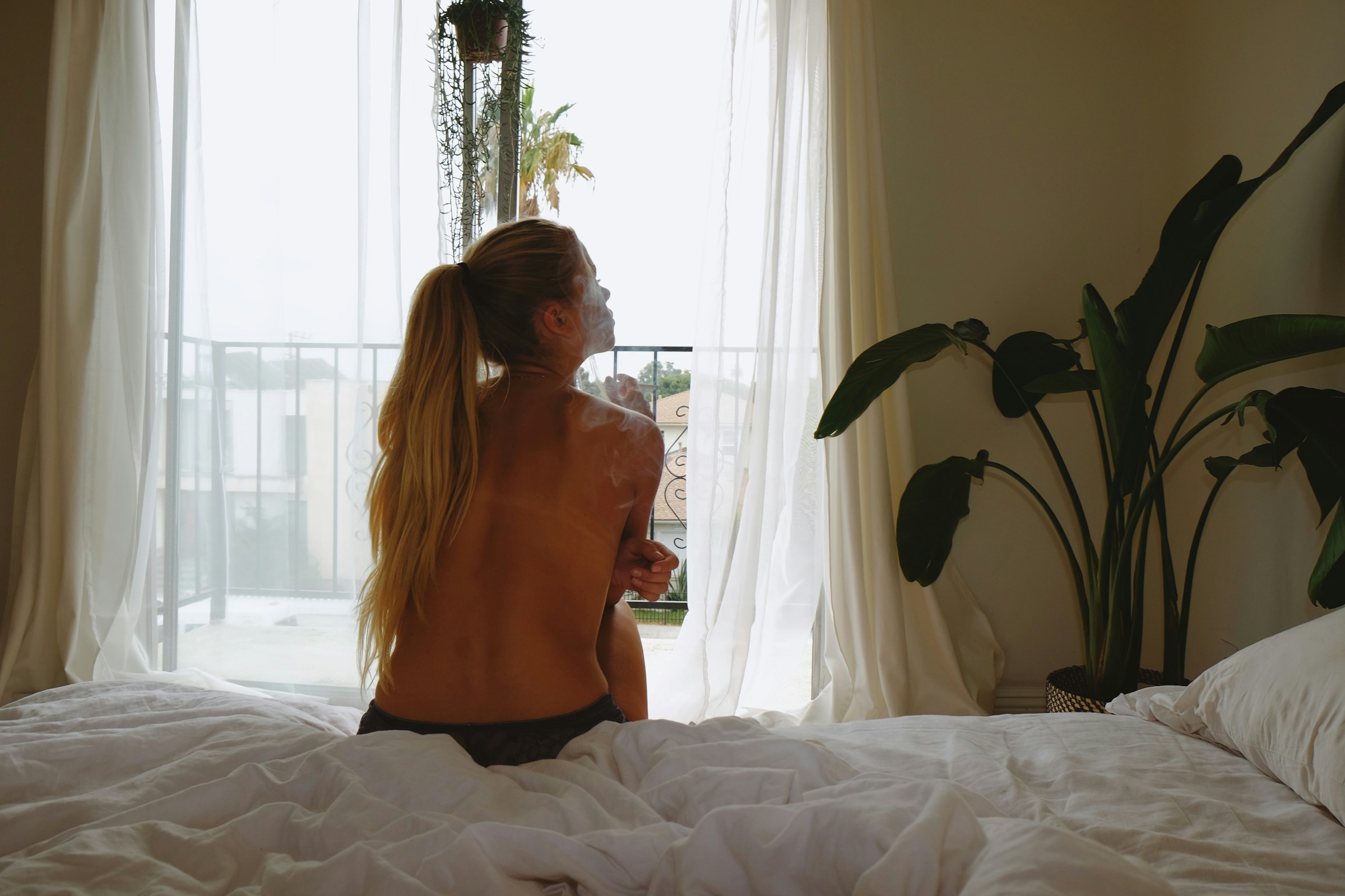 woman on bed - The 5 AM Club Morning Routine