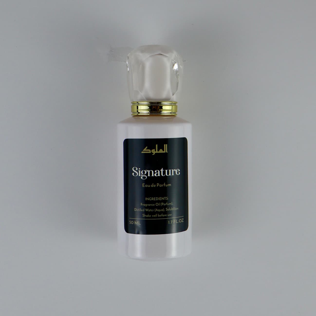 Signature Eau de Parfum bottle with dark label on white background.