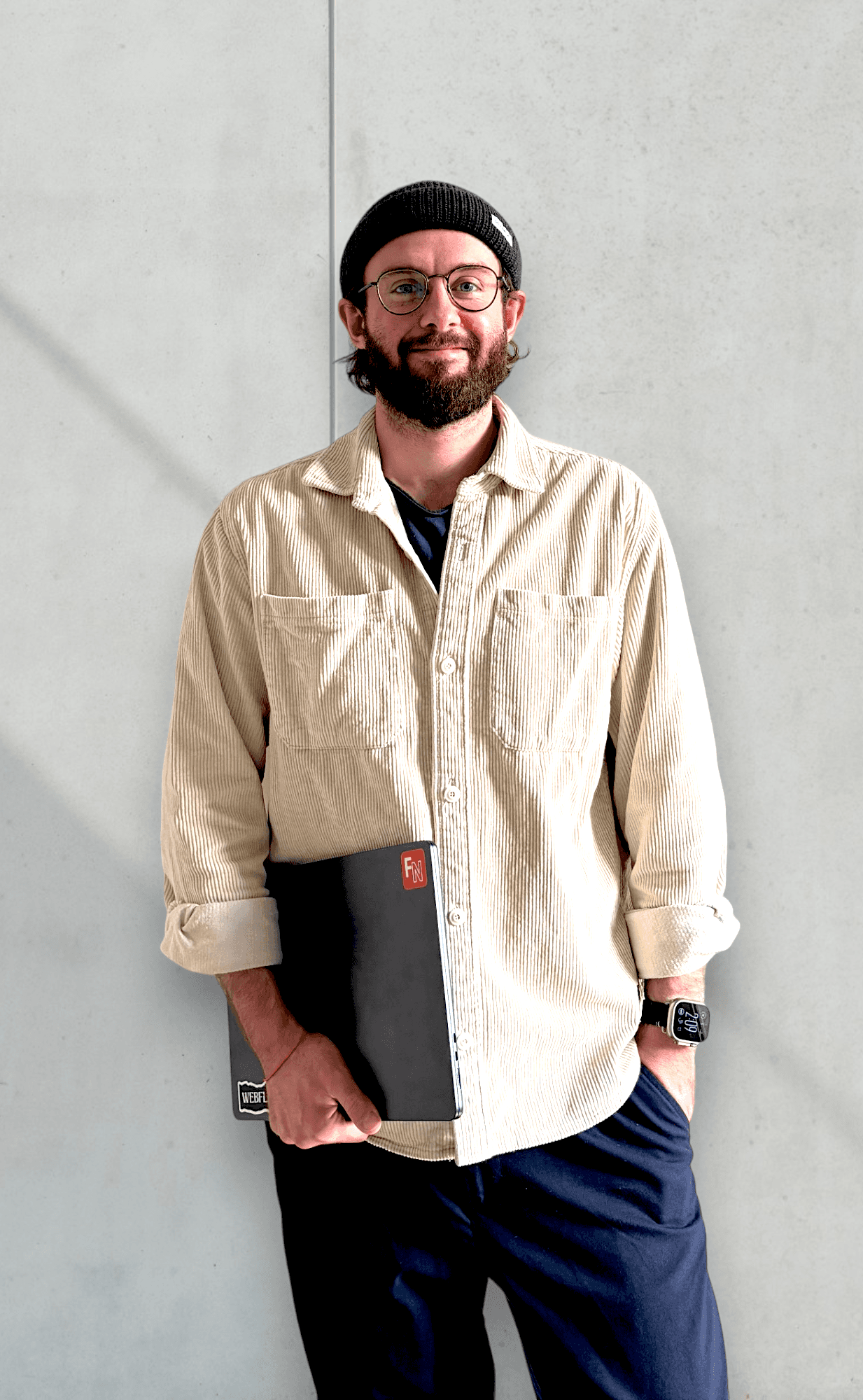 Photo of Fabio Nobile sitting in front of a computer wearing a beige shirt and beanie.