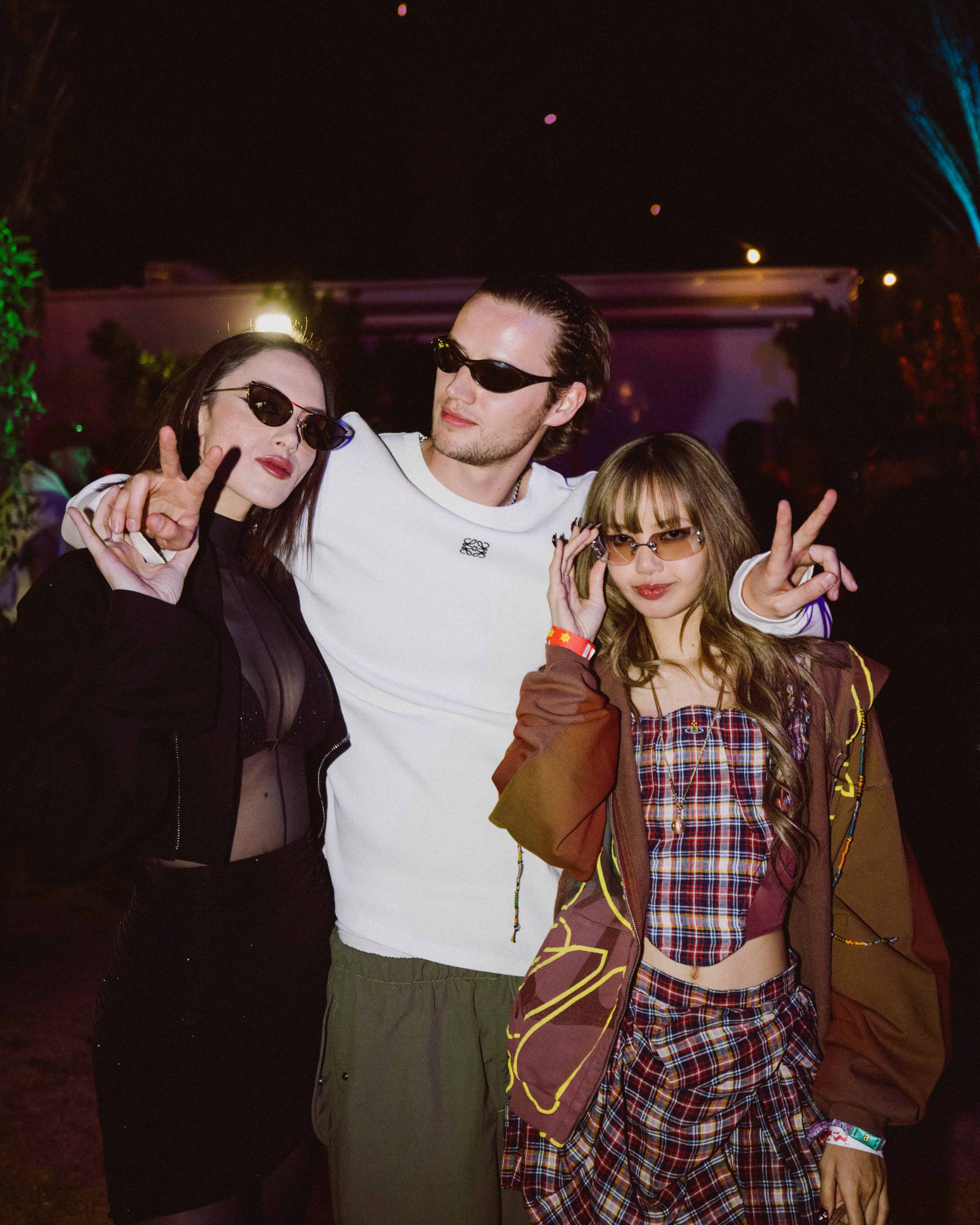 Sara Landry, MAU P, and LISA posing together backstage at Coachella 2025, captured by A World Away creative director Brandon Densley