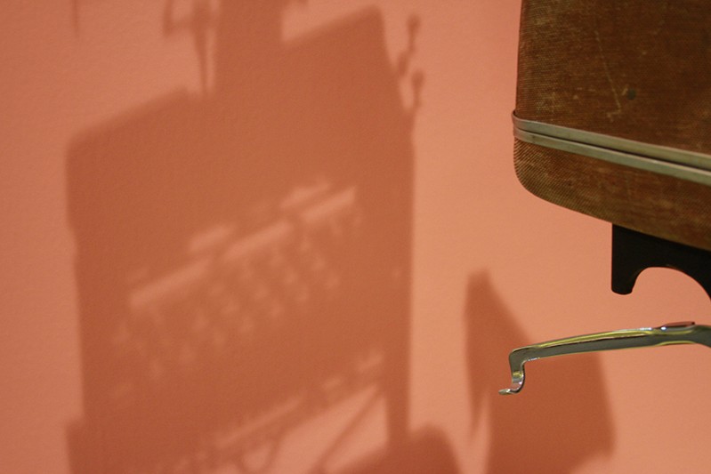 coral color wall with typewriter shhadow