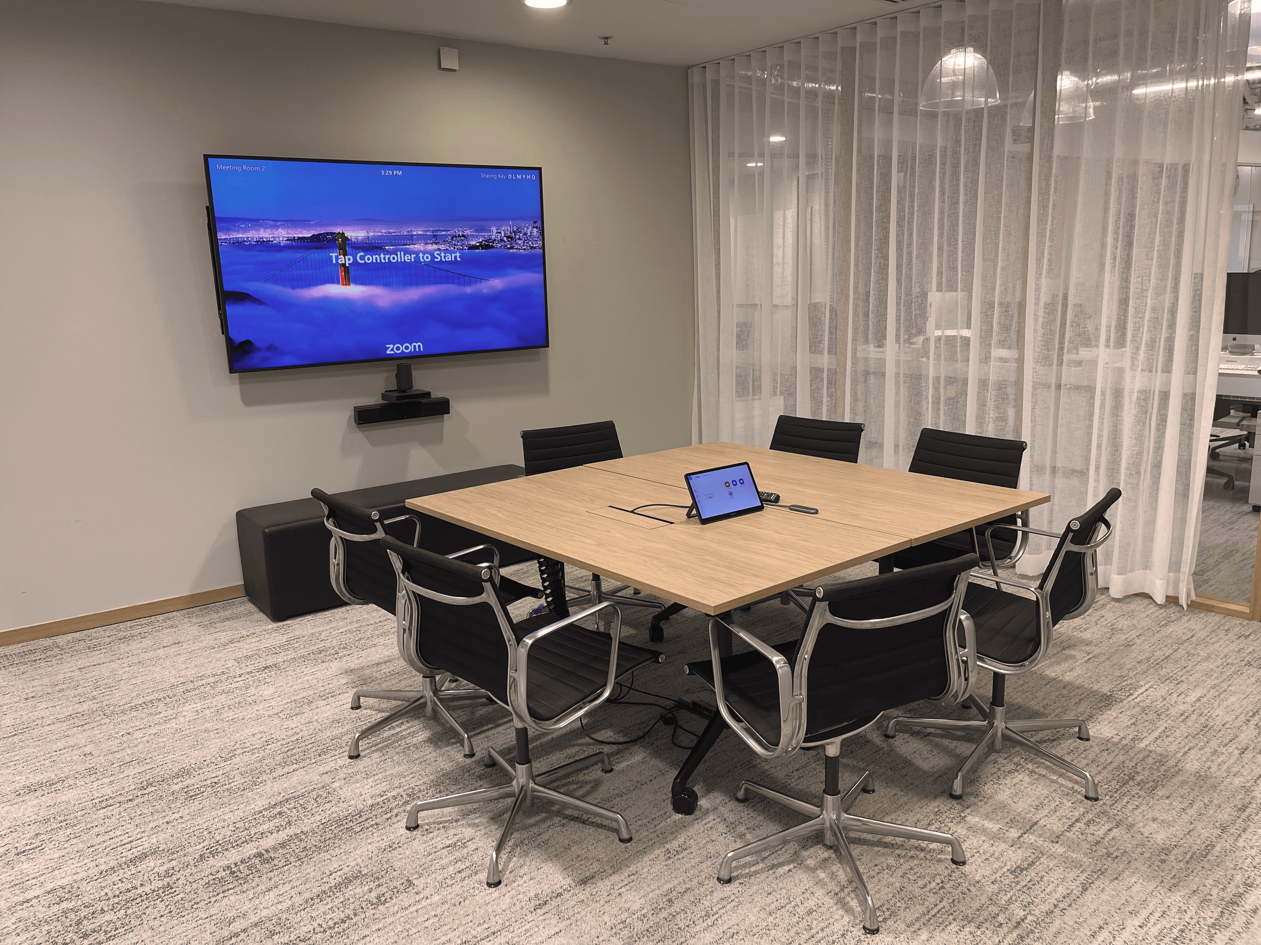 Photo of meeting room with screen, table and chairs