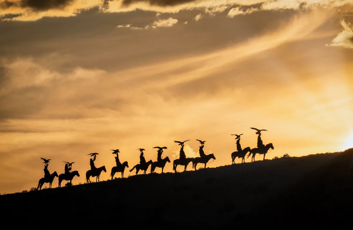 Cazadores Kazajos con sus aguilas doradas al atardecer, Mongolia