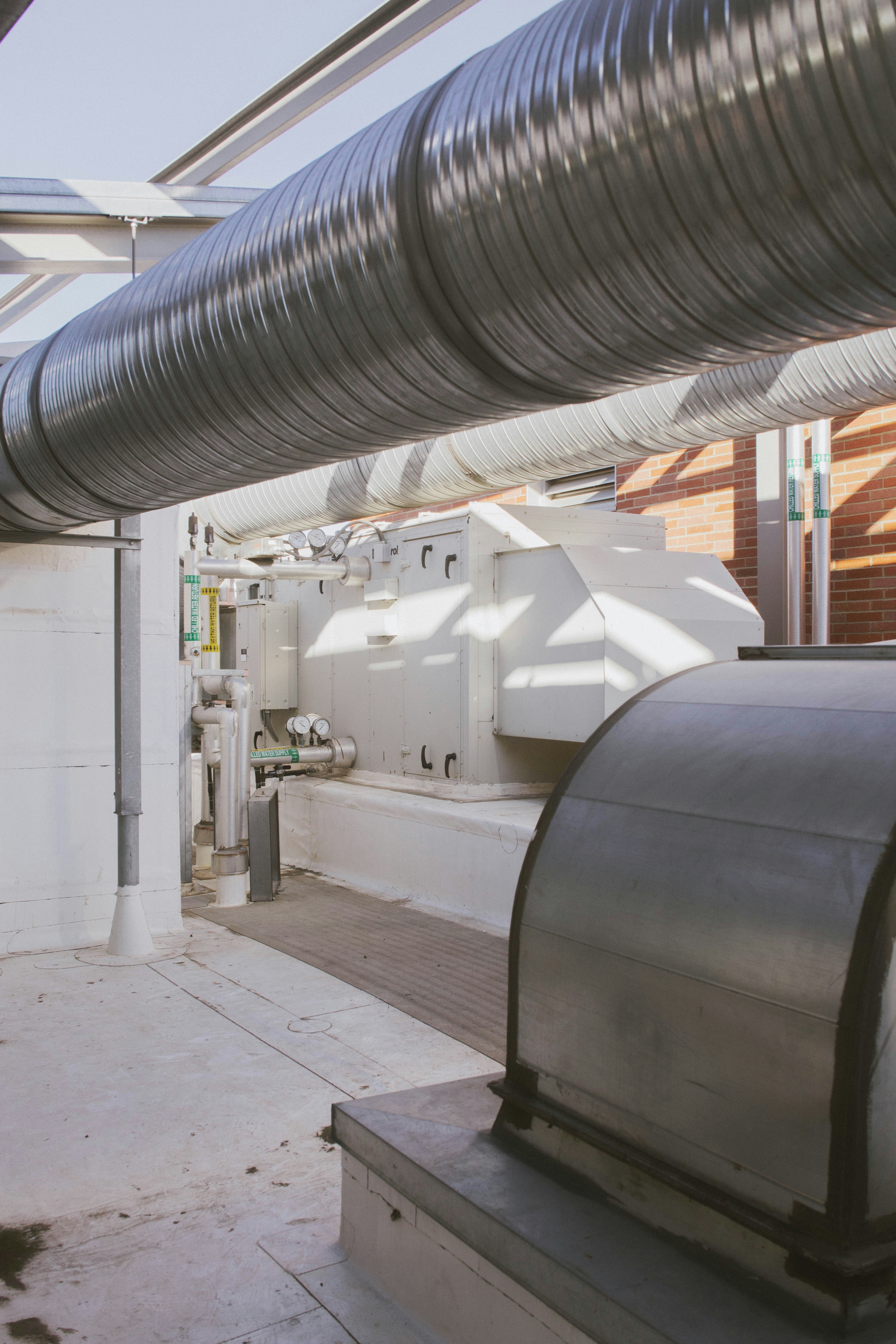 a room with a lot of pipes and a sink