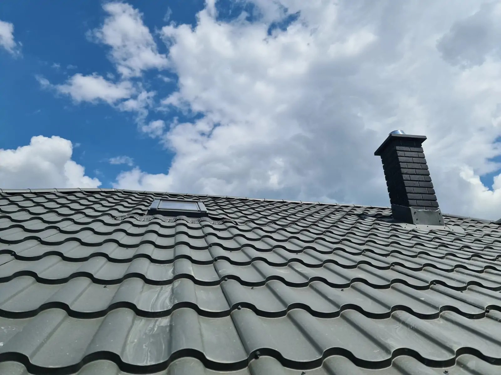 Black Kaminhorn chimney system on a grey tiled roof
