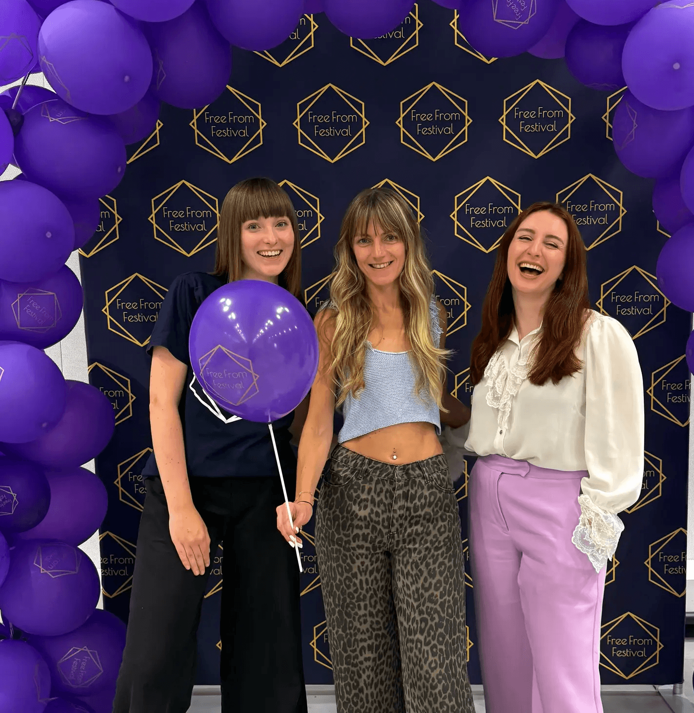 Margarita, Morgan and Ellie Standing in front of free from festival balloon arch