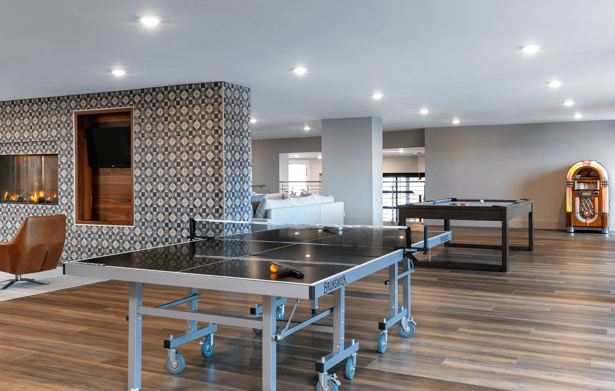 A spacious, modern kitchen with bright lighting, stainless steel appliances, and wooden accents.