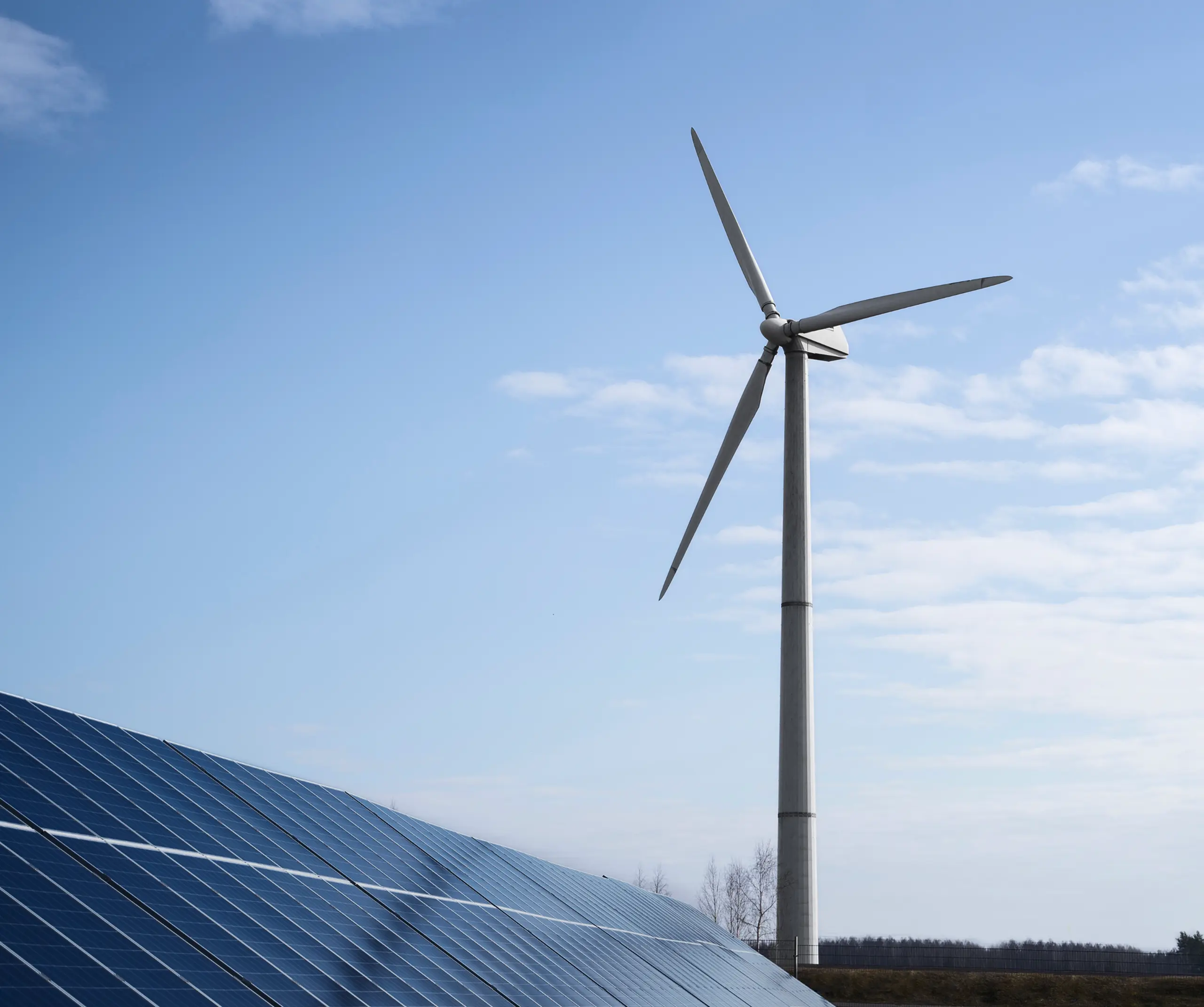 windmill and solar panel in broad daylight