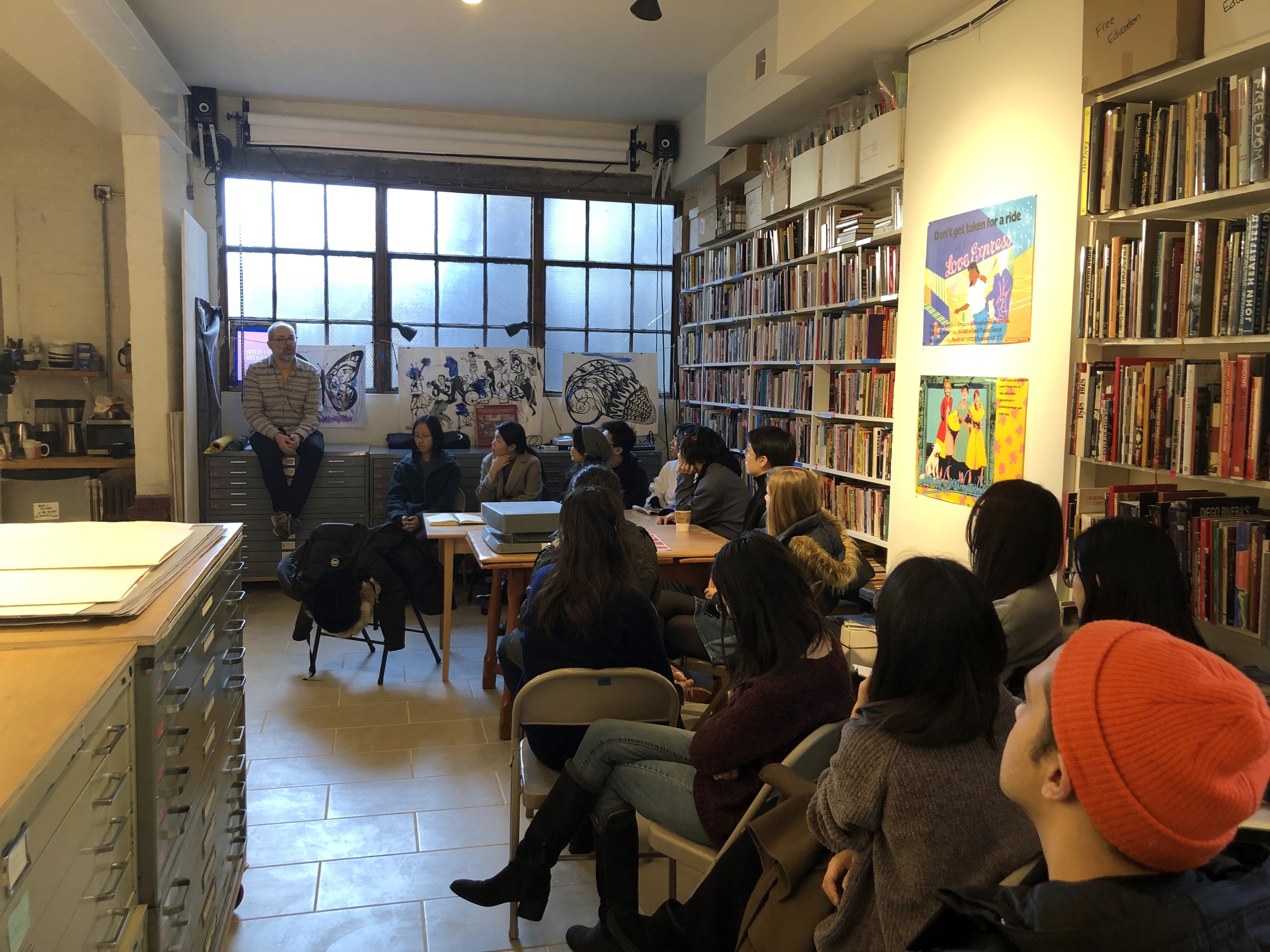 Josh MacPhhee at the library with group of students
