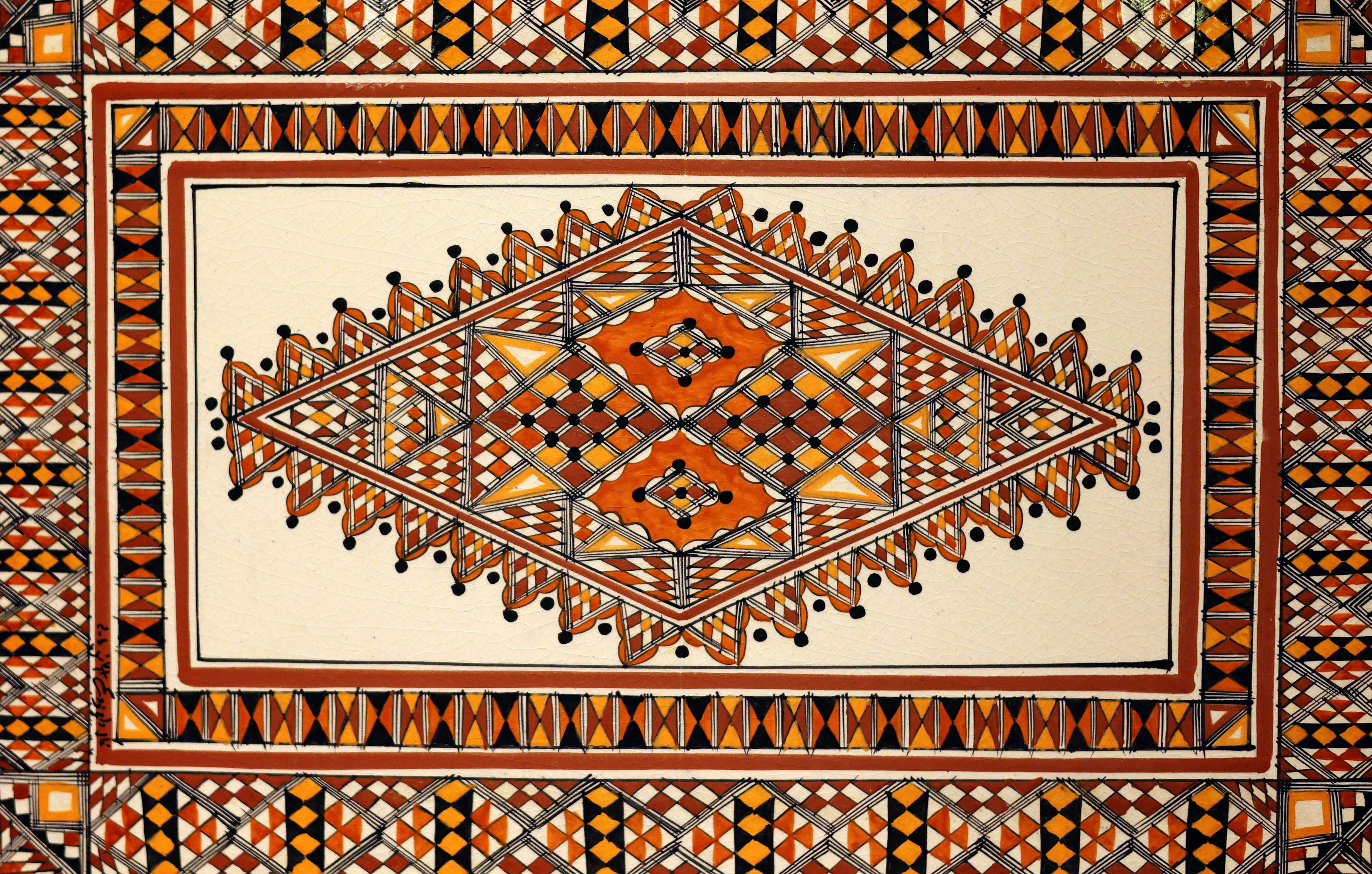 Intricate geometric mosaic pattern with orange and brown accents