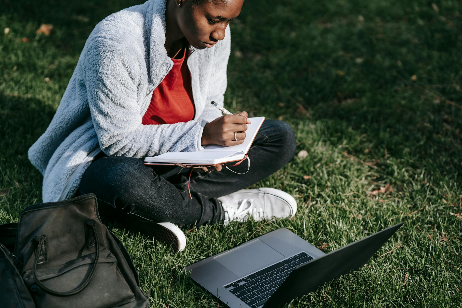 Student drafting an email to a college coach on a laptop