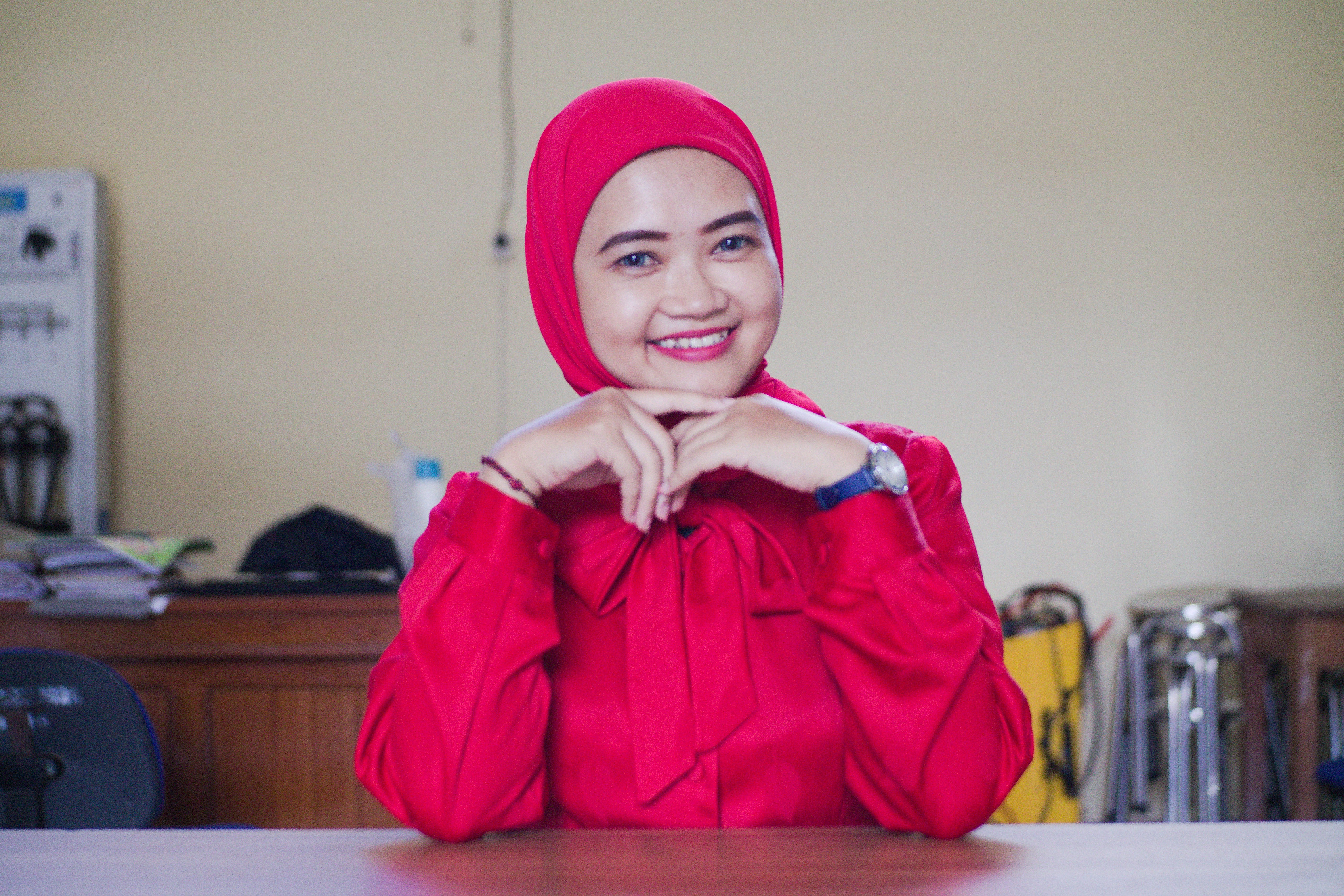 Close-up of a dark green leaf showing its textured surface and central vein against a muted background.