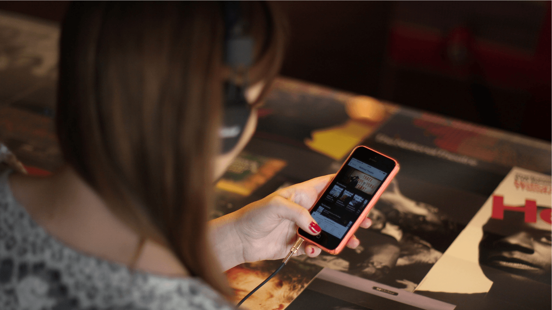 A woman browsing the national theatre website on mobile